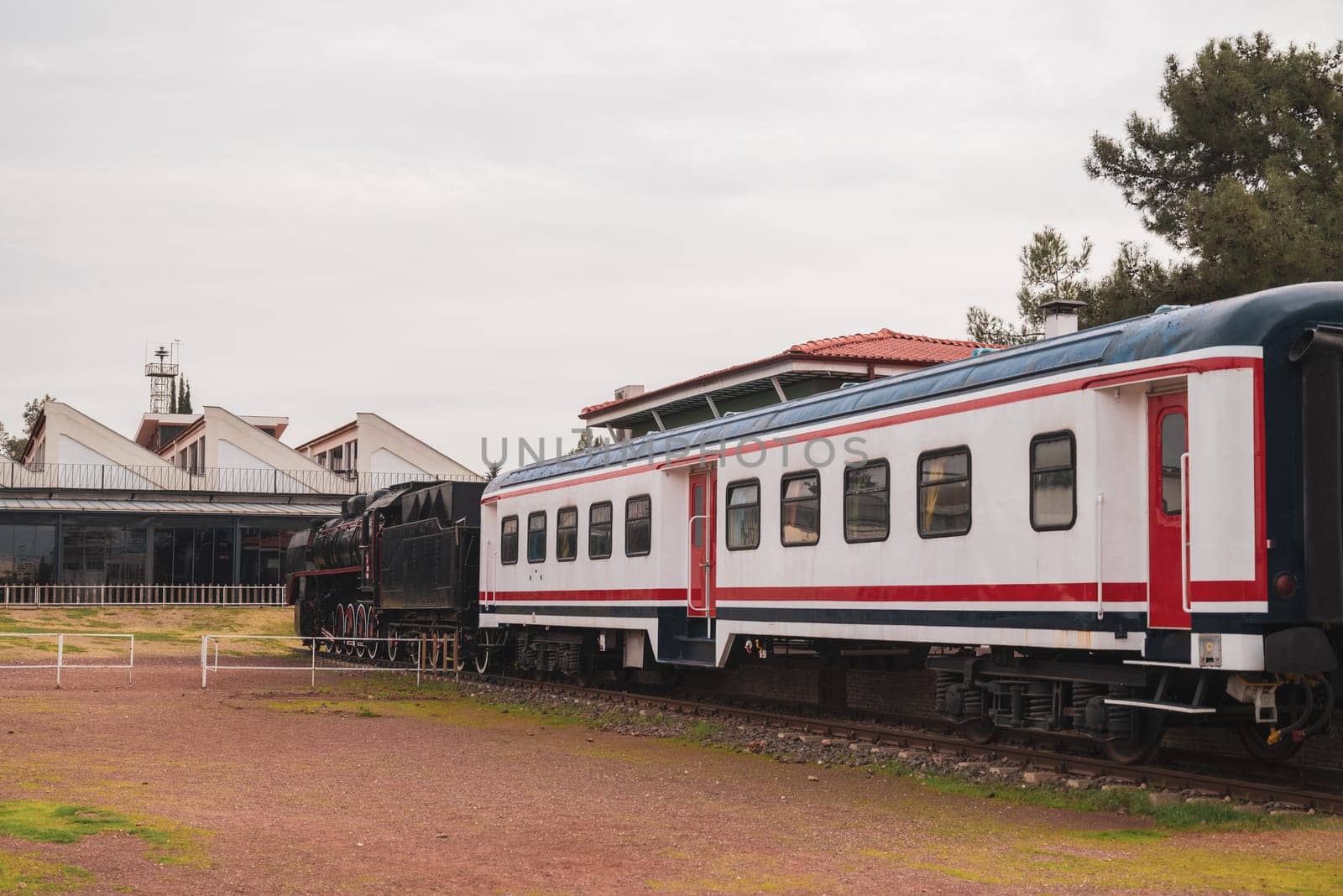 Vintage passenger train waiting for passengers at the train station by Sonat