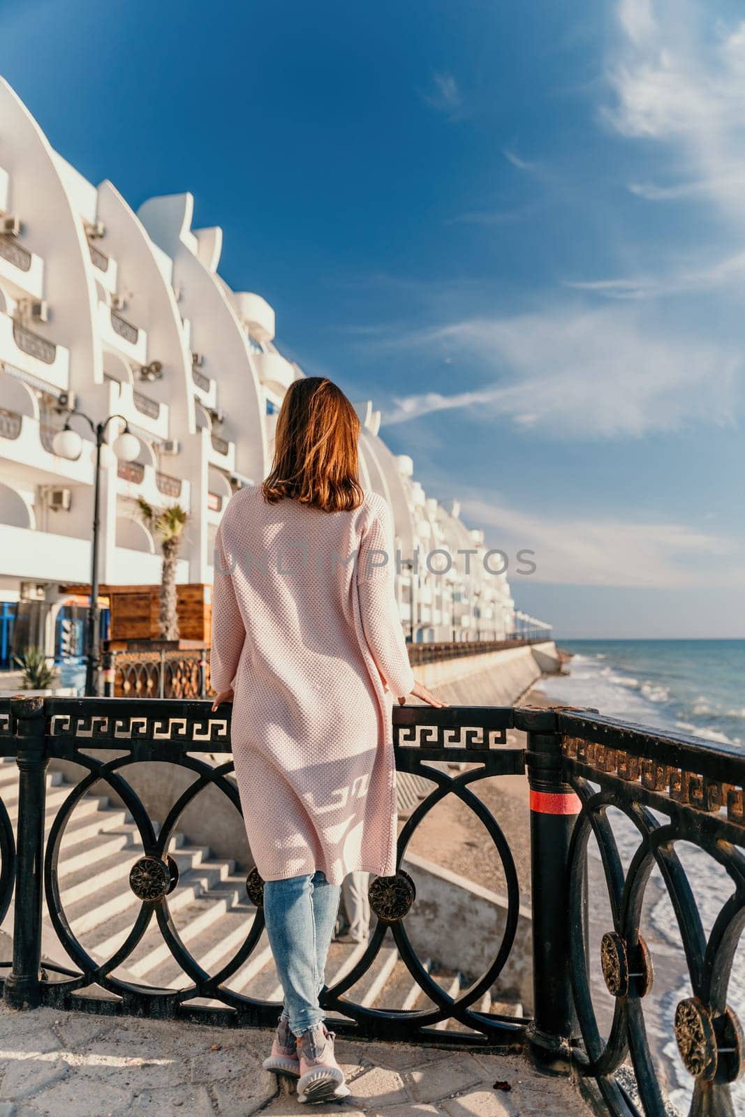 Woman summer travel sea. Happy tourist enjoy taking picture outdoors for memories. Carefree woman traveler posing on beach at sea on sunset, sharing travel adventure journey. Holiday vacation concept. by panophotograph