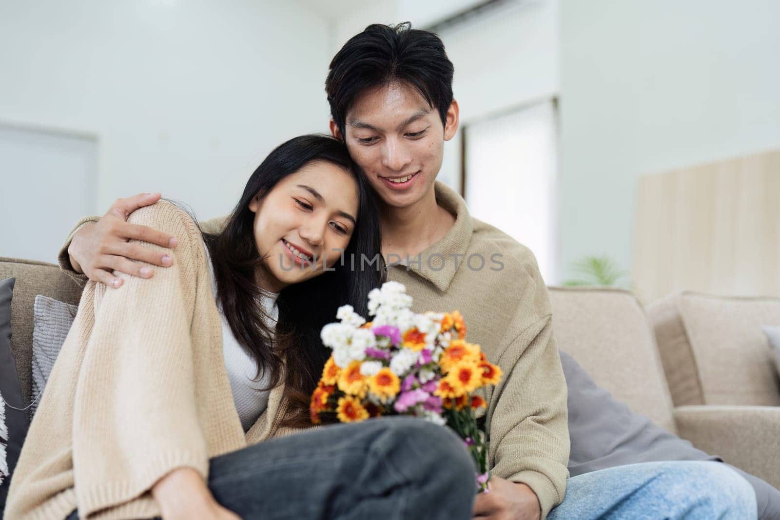 Young couple Hug and giving flower on Valentine's Day. Romantic day together. Valentine's Day concept.