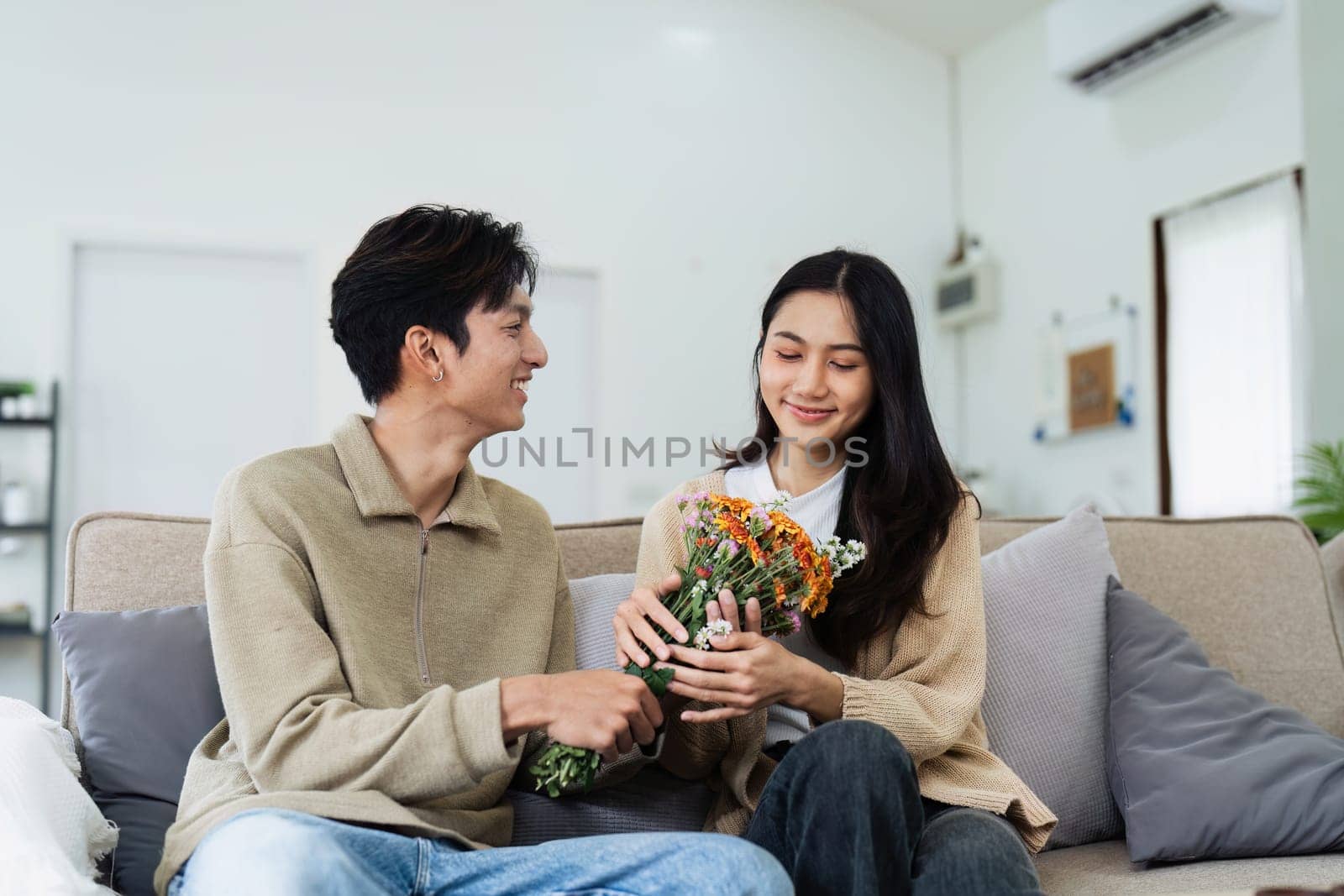 Young couple Hug and giving flower on Valentine's Day. Romantic day together. Valentine's Day concept.