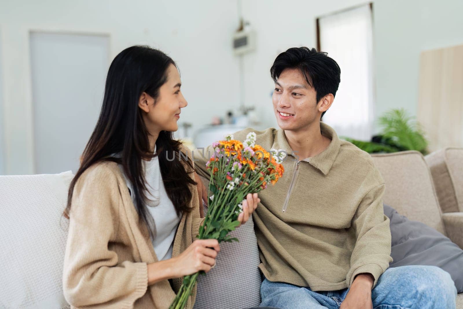 Young couple Hug and giving flower on Valentine's Day. Romantic day together. Valentine's Day concept.