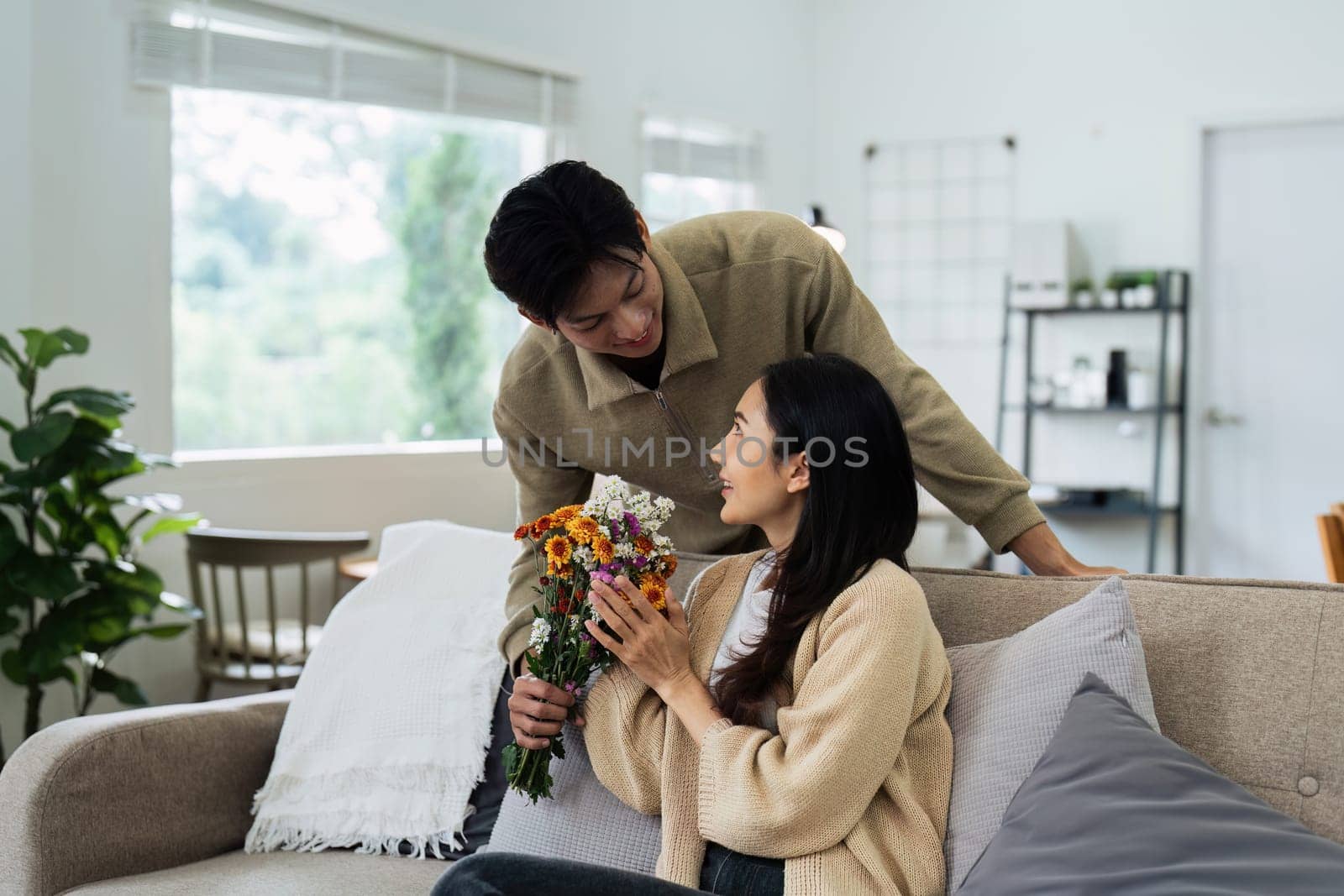 Young couple Hug and giving flower on Valentine's Day. Romantic day together. Valentine's Day concept.