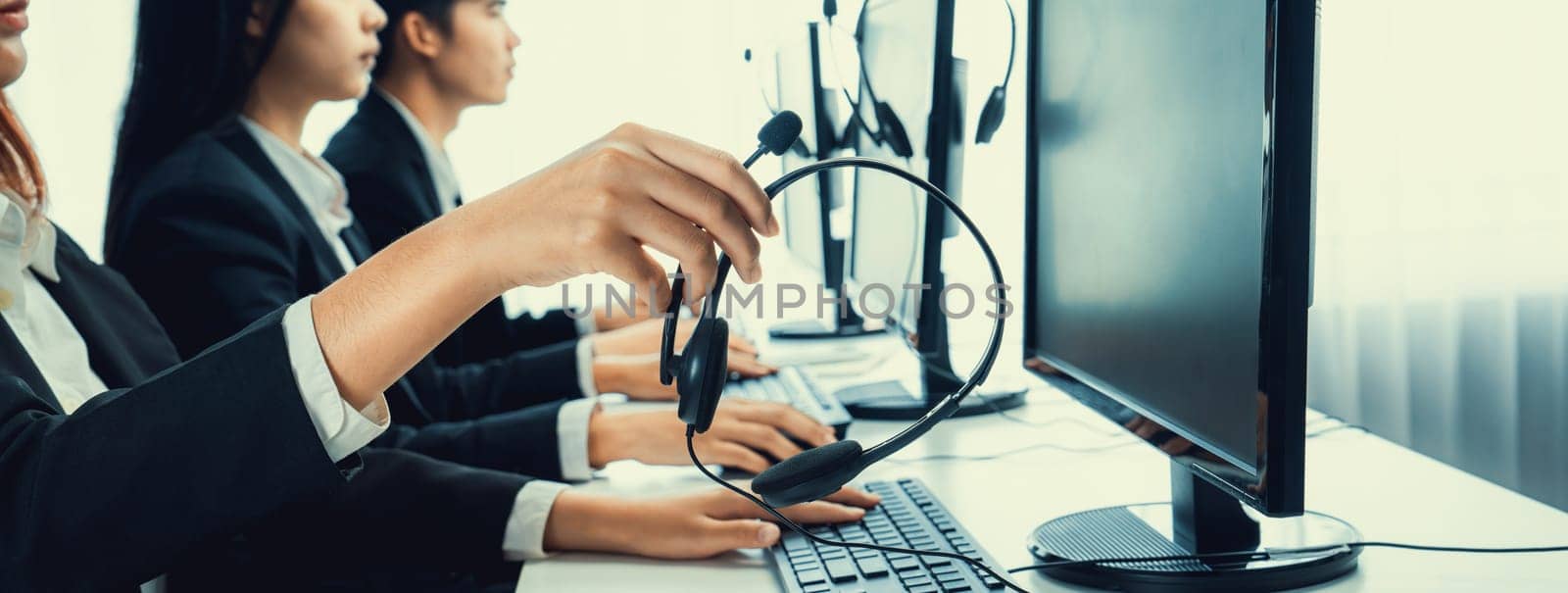 Call center wearing headset working in office for customer support oratory by biancoblue