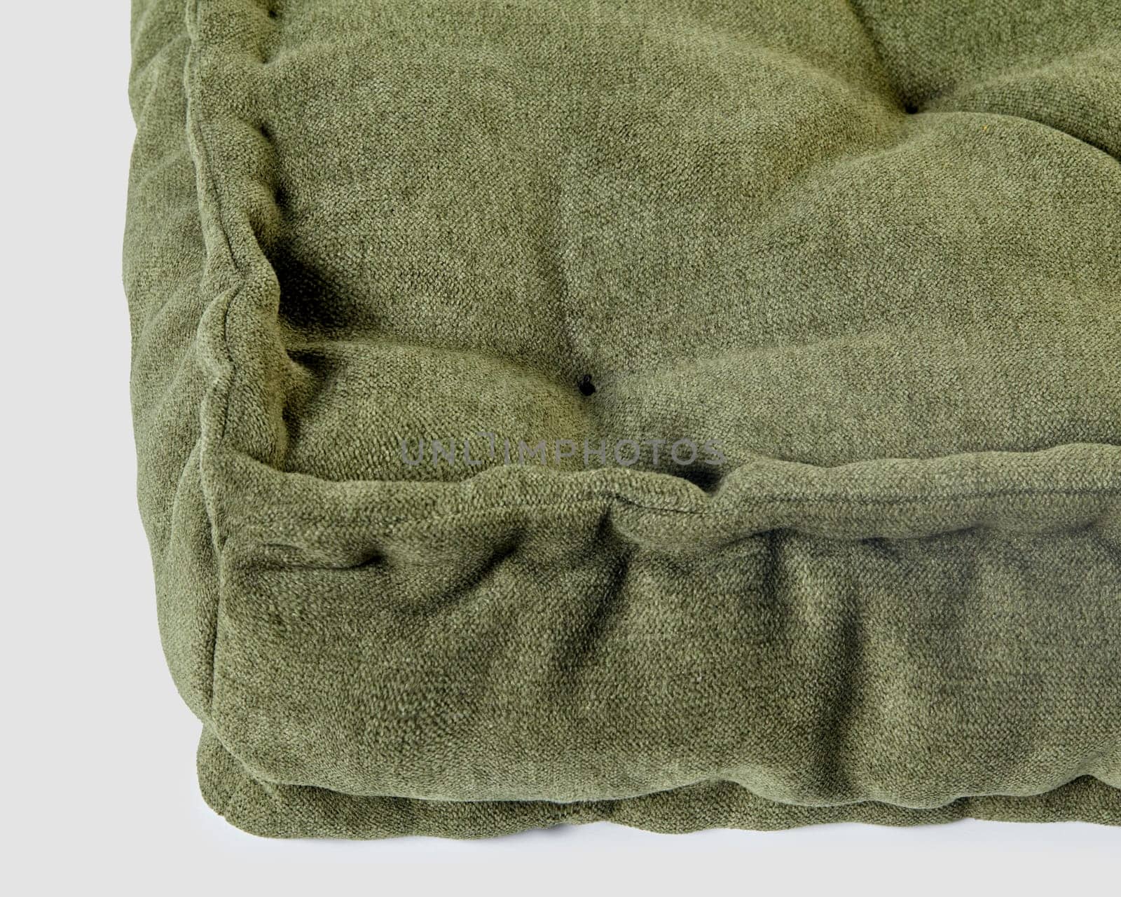 Closeup detailed image of cozy green linen floor cushion, exemplifying comfort and style with soft, ruffled texture and durable design. Handmade accessory for home decor