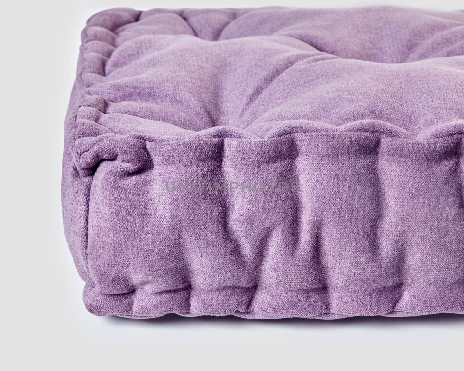 Detailed close-up of plush purple linen cushion on white by nazarovsergey