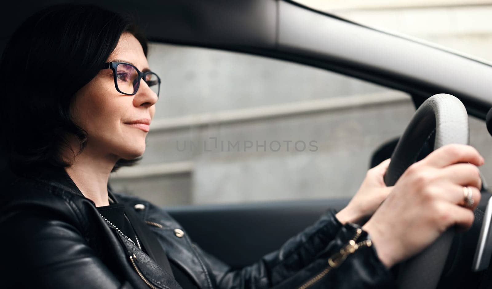 Business Woman Driving A Car By Modern City