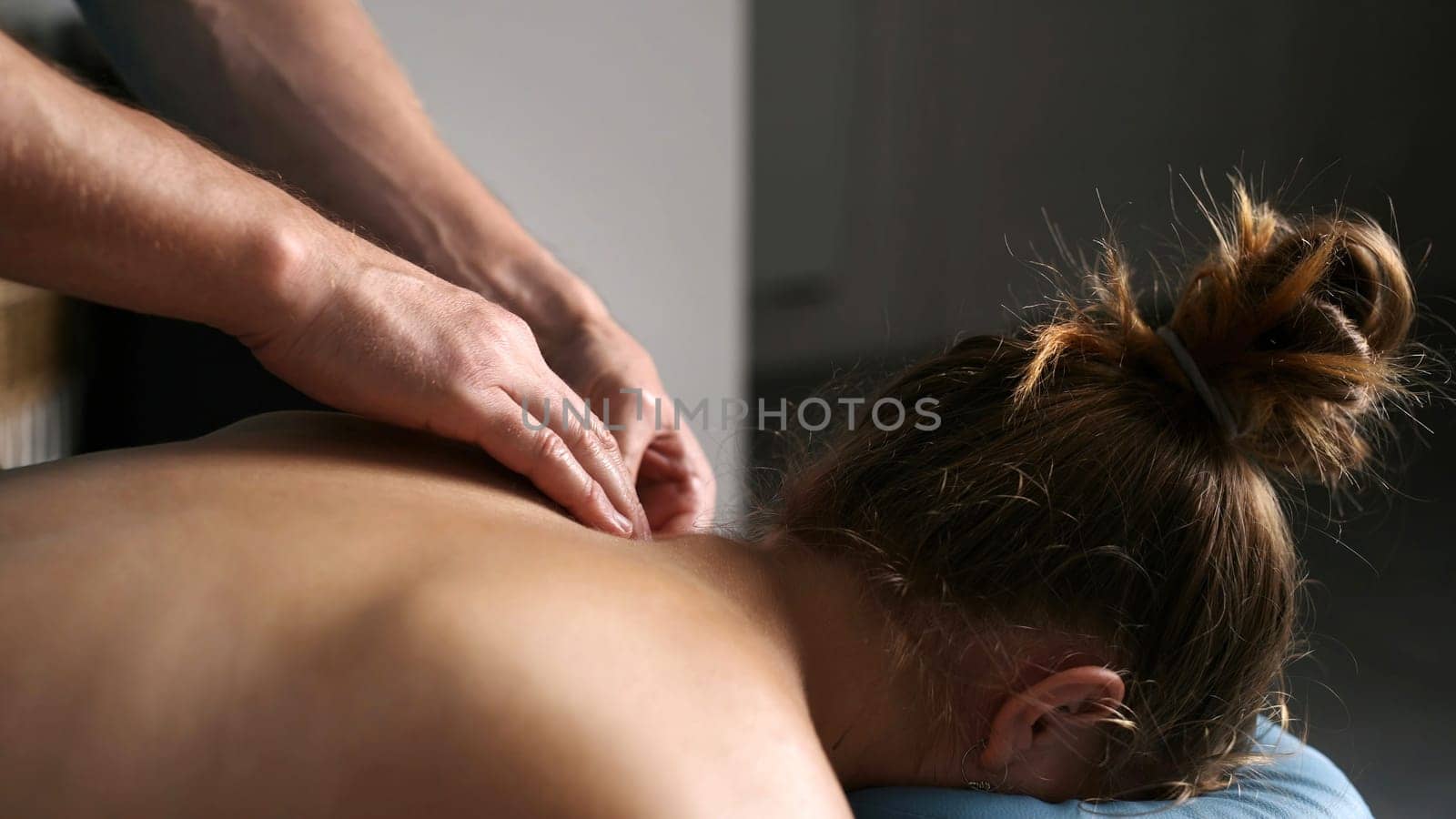 Massage Therapist Doing Shoulders Massage In Spa by GekaSkr
