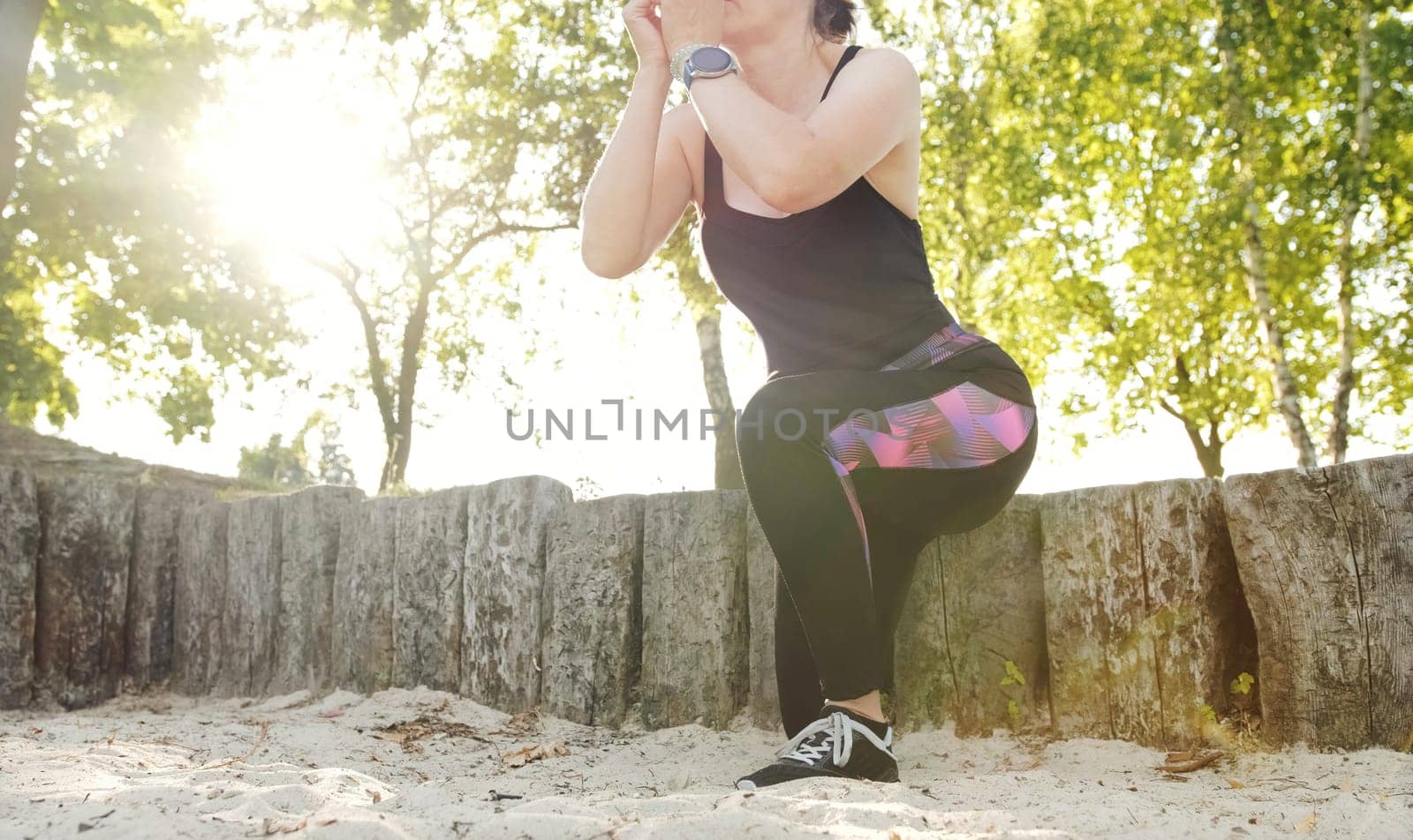 Fitness girl doing squats on the one leg, hip and knee joint muscles training, outdoor recriation