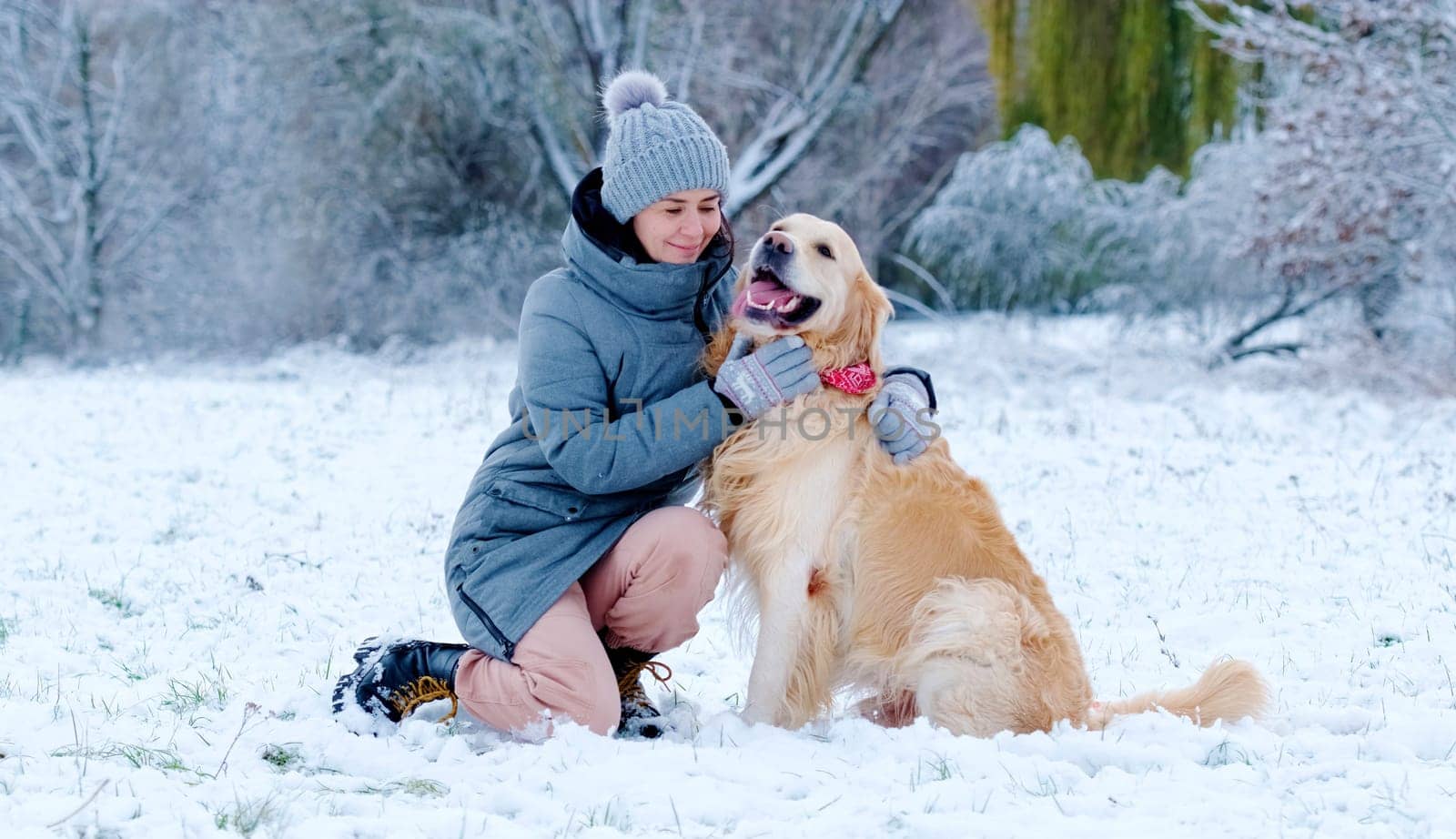 Girl Hugging Her Pretty Golden Retriever Dog Outdoors In Winter by GekaSkr