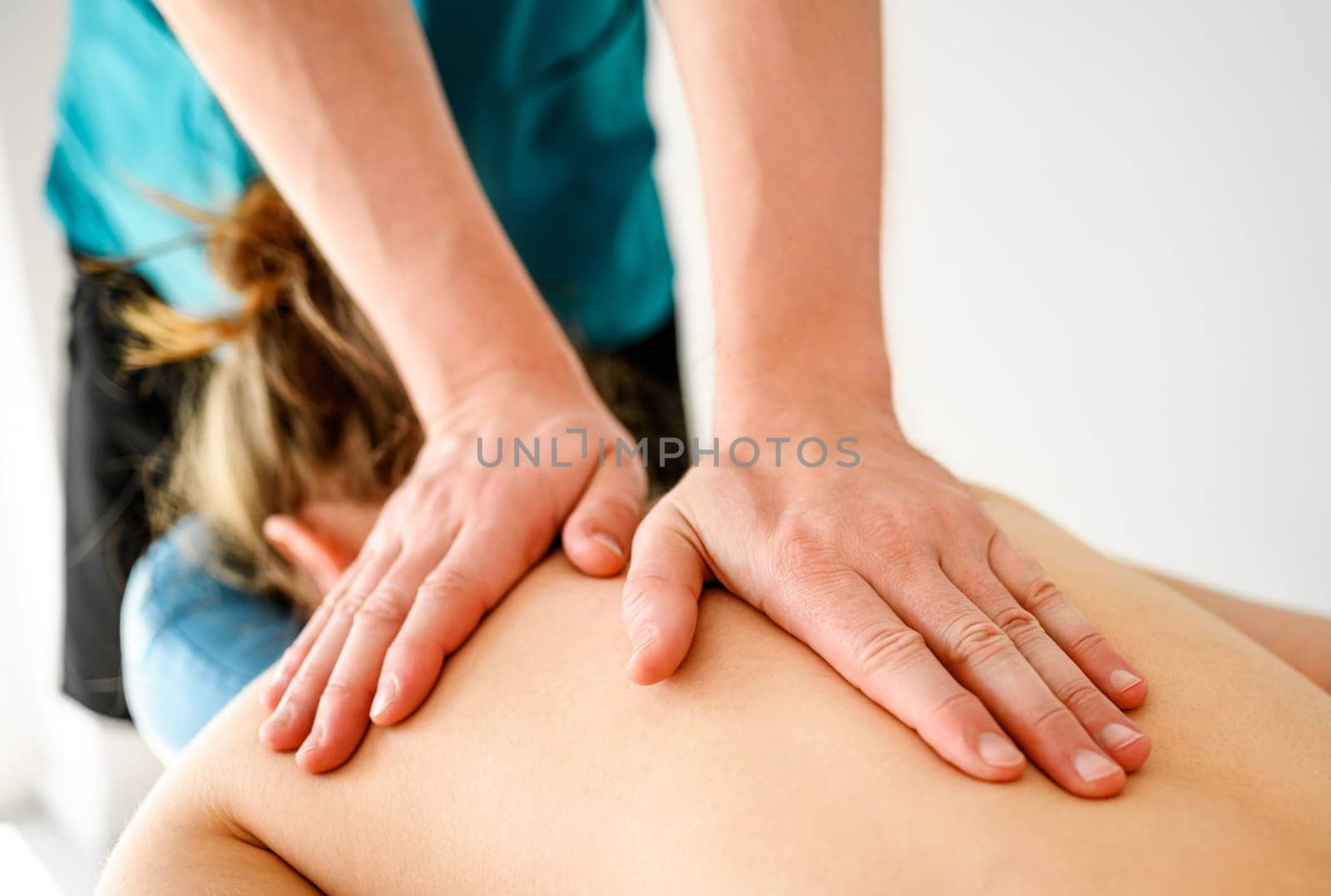 Massage therapist doing back relax massage in spa by GekaSkr