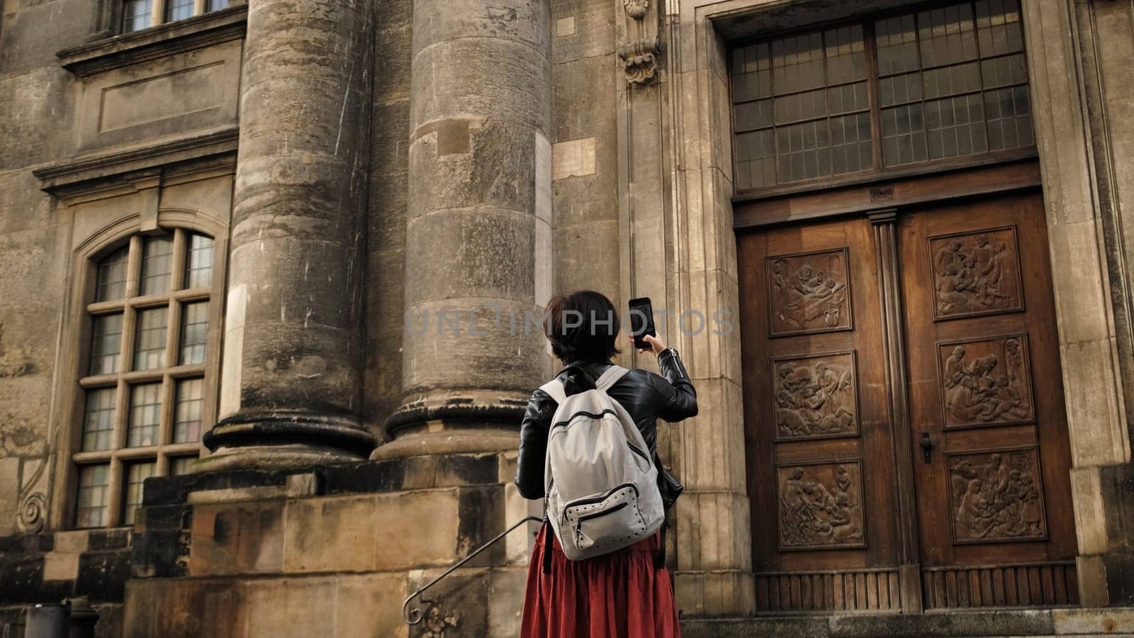 Beautiful Woman Tourist Strolls With German Flag In Dresden'S Historic Center by GekaSkr