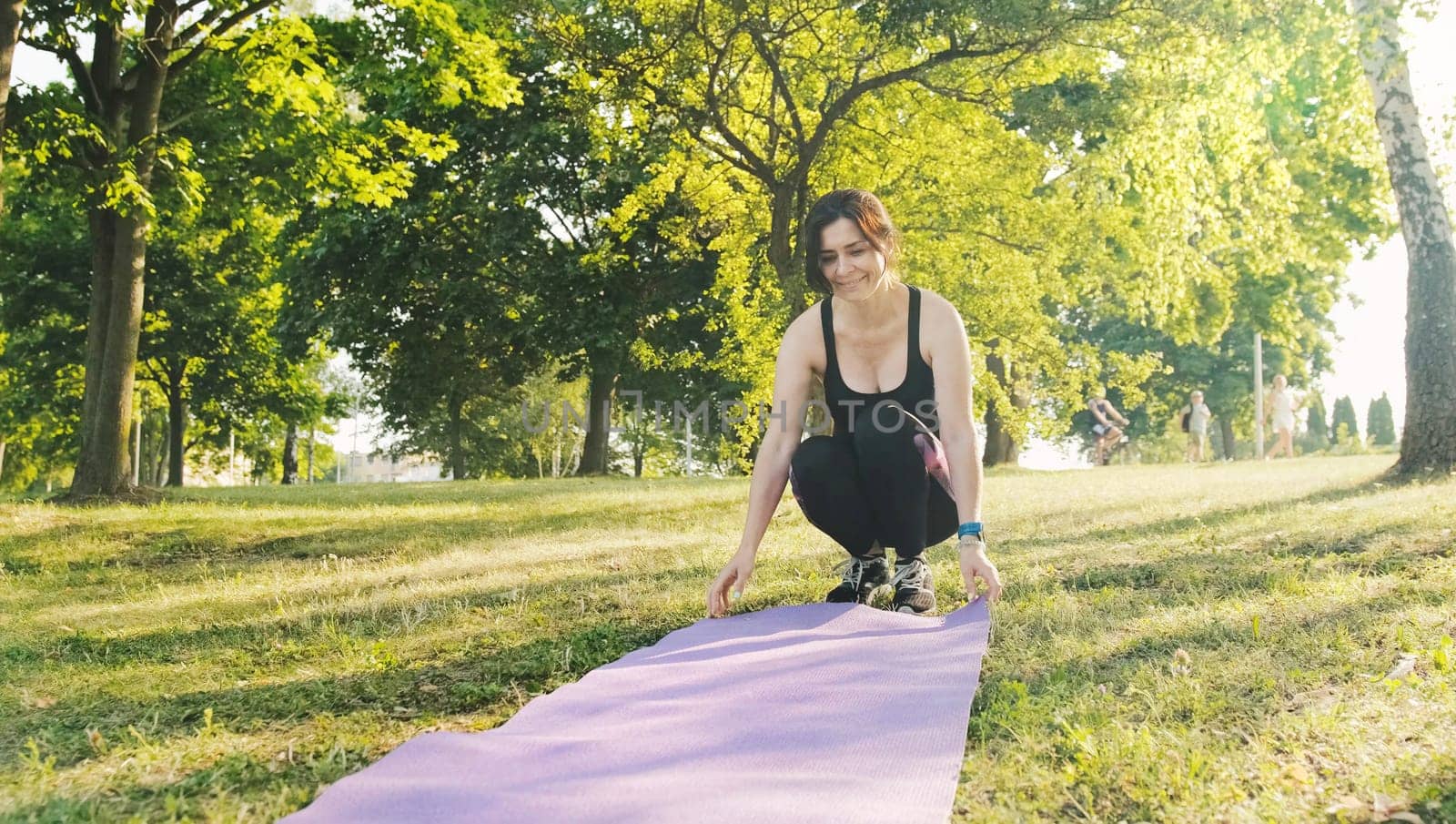 Fitness girl with a map for yoga preparing to practice yoga by GekaSkr