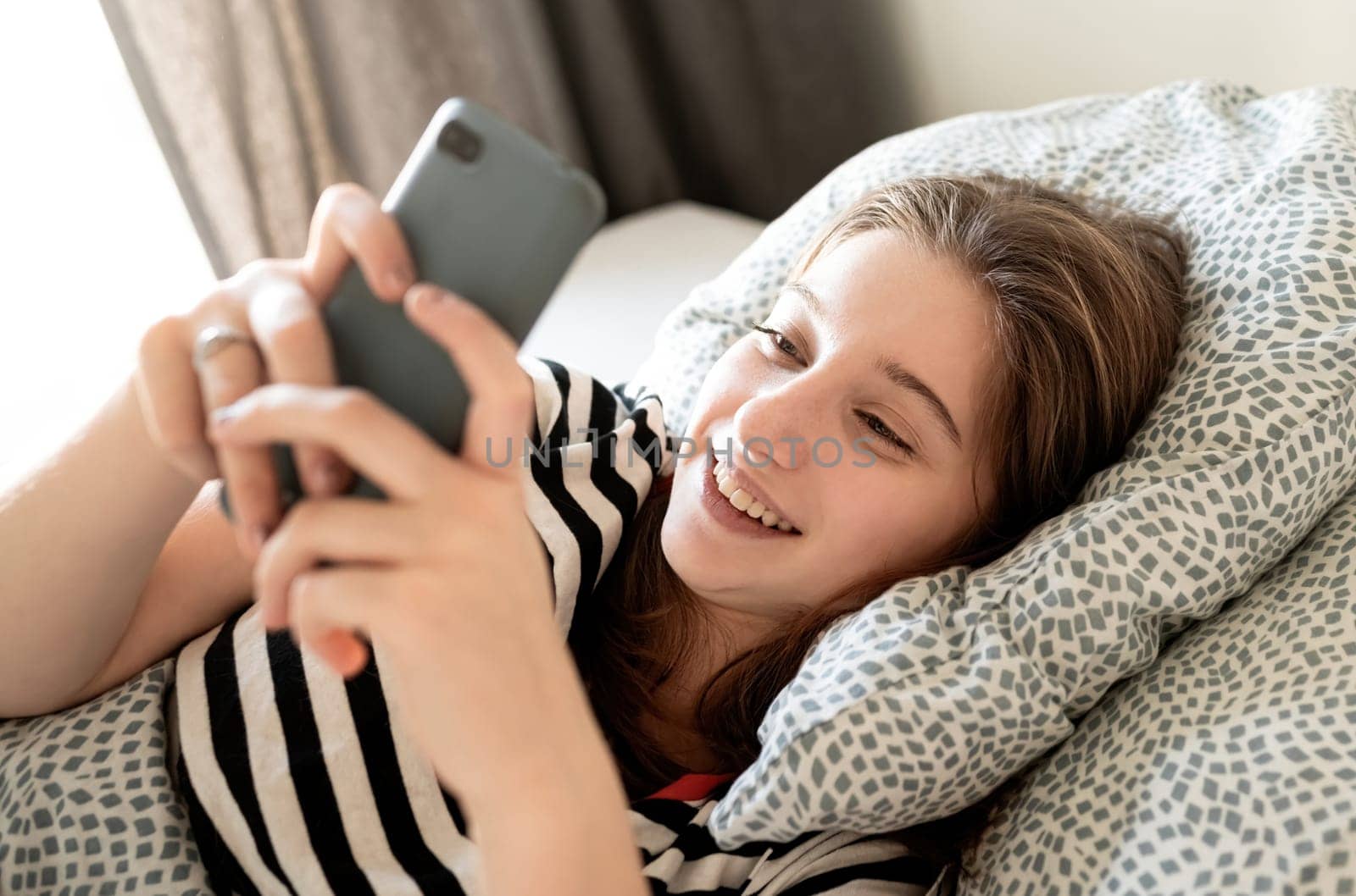 Teenage Girl Checking Social Medias And Messages On A Smartphone by GekaSkr