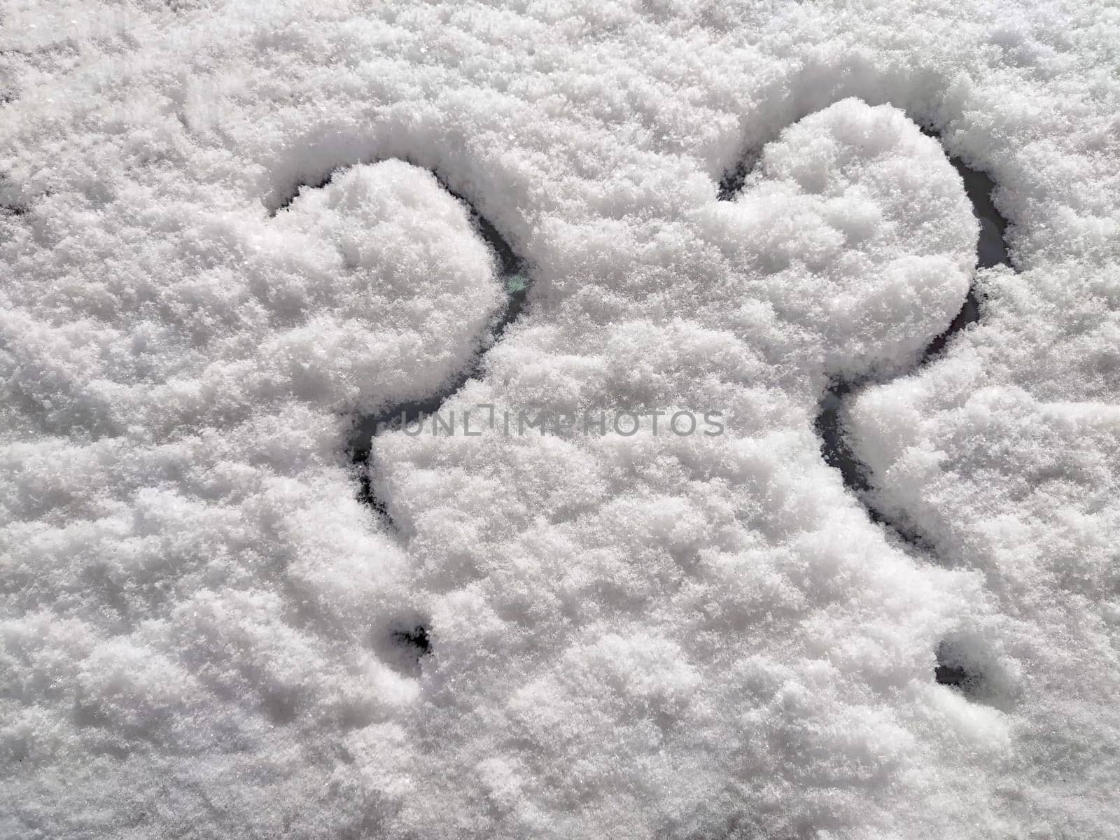 Two question marks written in snow. The cold frosty texture of the snow and the question mark. Background, place for text, copy space