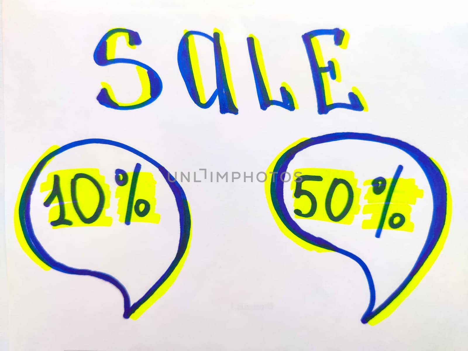 White sign with a yellow and blue inscription sale. The concept of a sale offer in business, trade, store. Blackboard with the word sale handwritten on it isolated against a white background