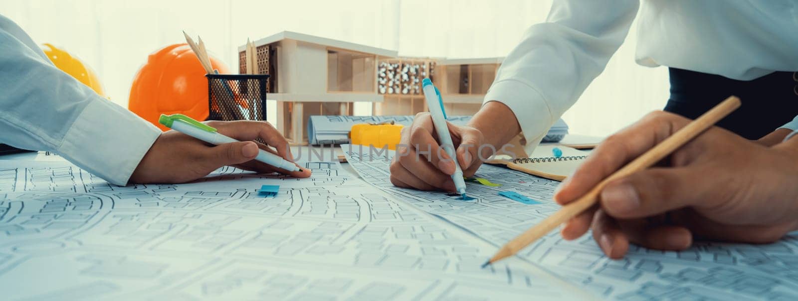 Worker, architect and engineer work on real estate construction project oratory planning with cartography and cadastral map of urban town area to guide to construction developer business plan of city