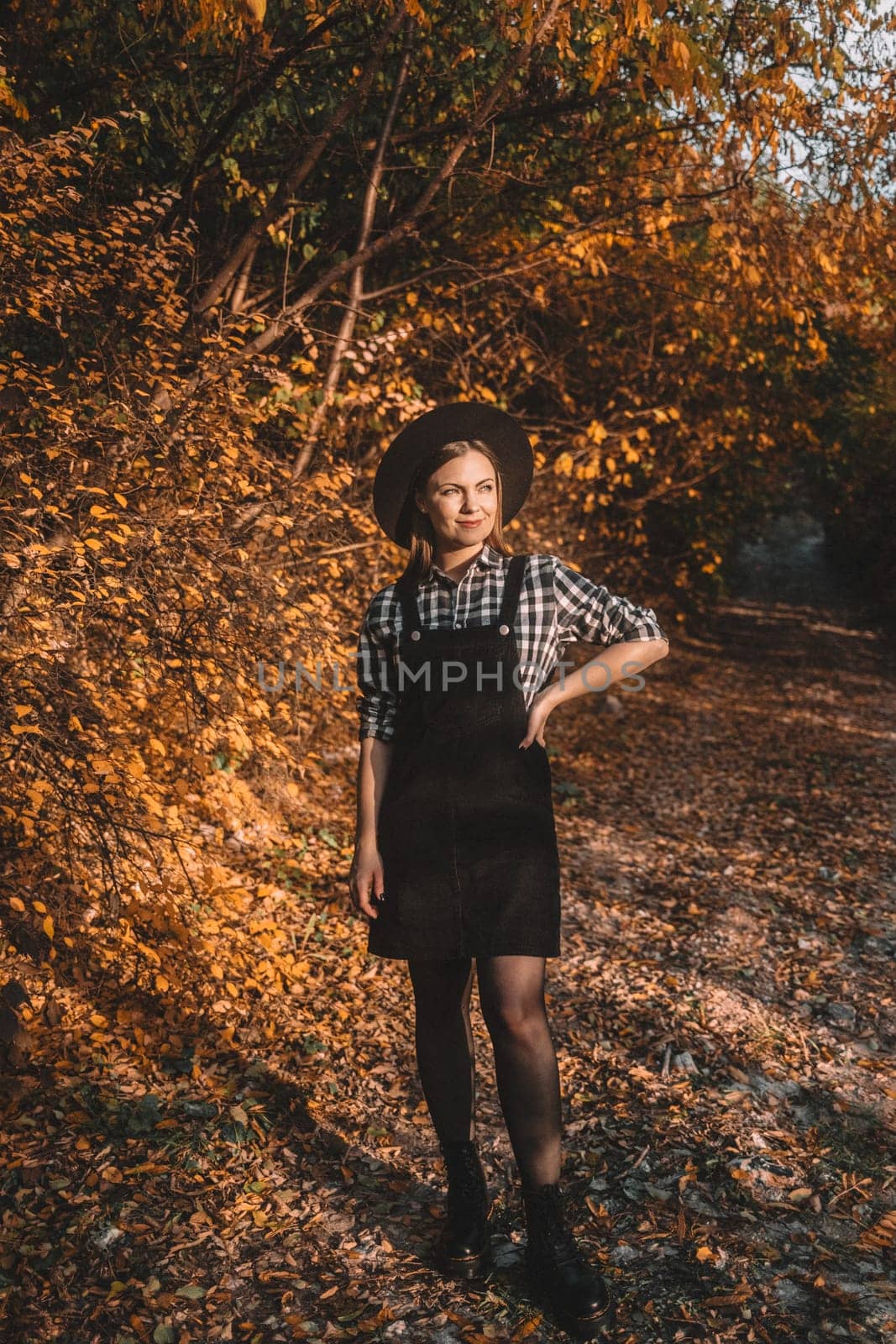 Hipster woman portrait, autumn park, beautiful golden nature. Lifestyle, hat. High quality photo