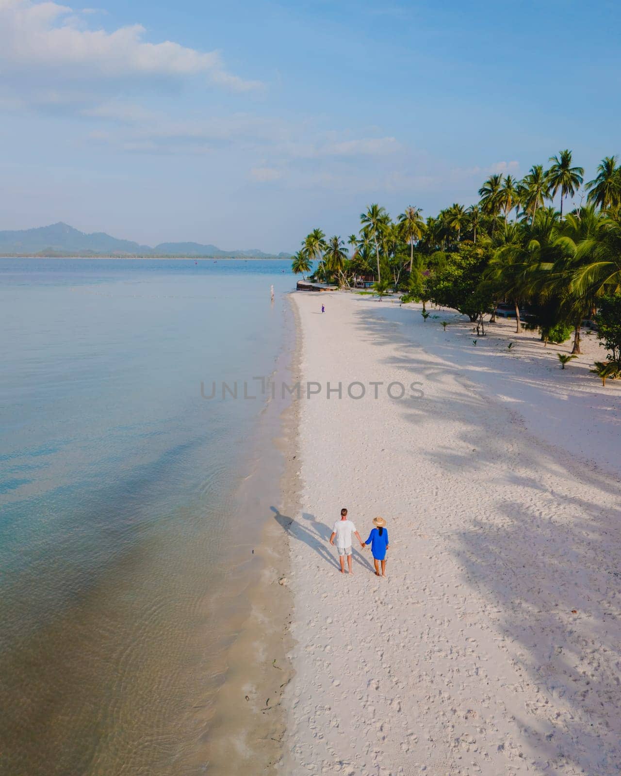 Koh Mook Drone view at a couple walking on the white sandy tropical beach of Koh MukThailand by fokkebok