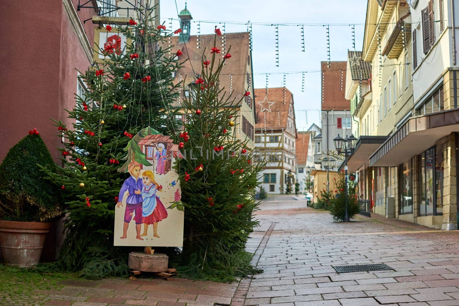 Winter Festivities in Bitigheim-Bissingen: Charming Half-Timbered Houses Adorned with Christmas Decorations. Step into the enchanting New Year's atmosphere of Bitigheim-Bissingen, Baden-Württemberg, Germany, where half-timbered houses line the streets, beautifully decorated with festive Christmas ornaments. The photograph is artfully processed in warm vintage tones, capturing the essence of winter joy in this picturesque town.