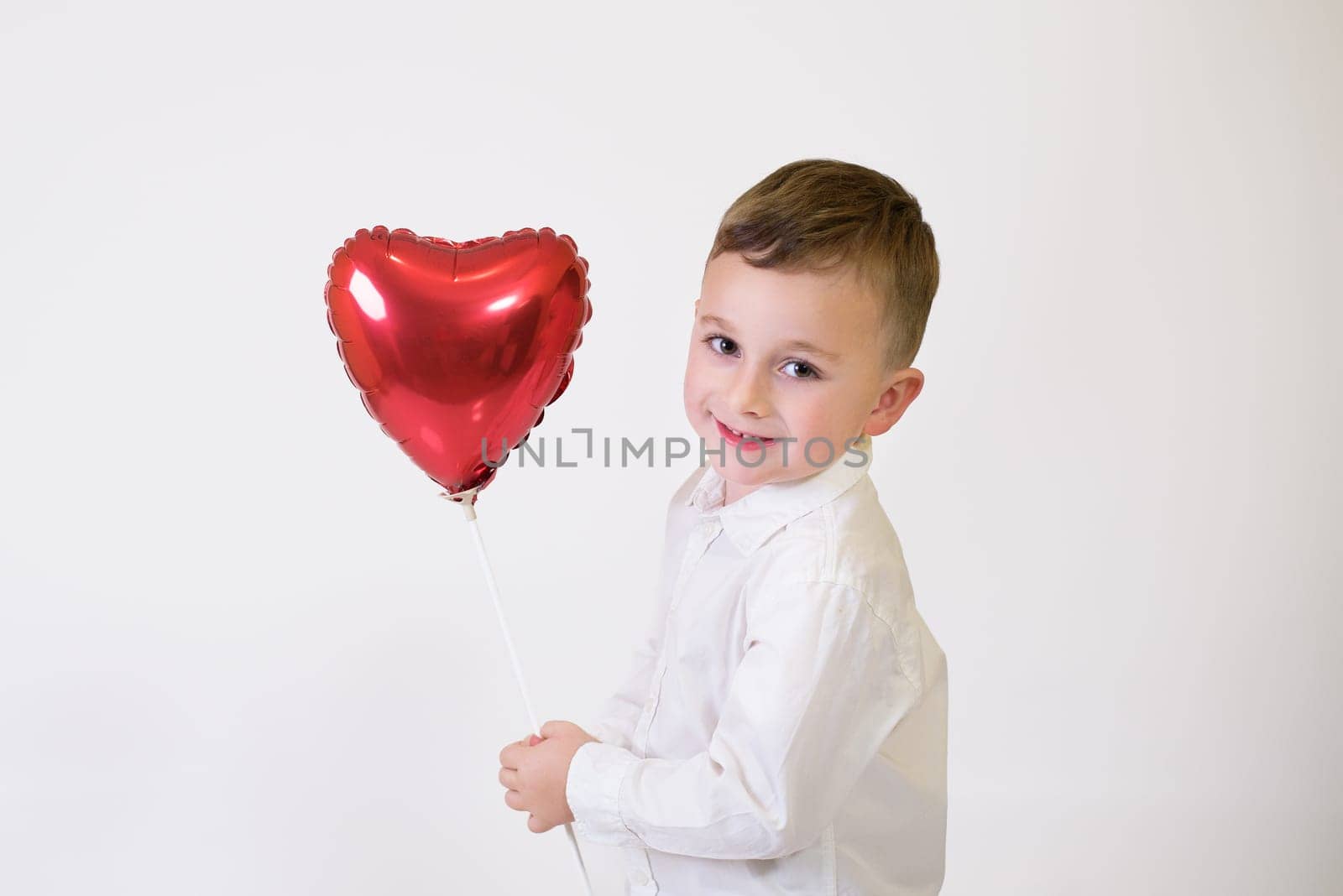 Little children with air balloons on white background. Valentine's Day Celebration.