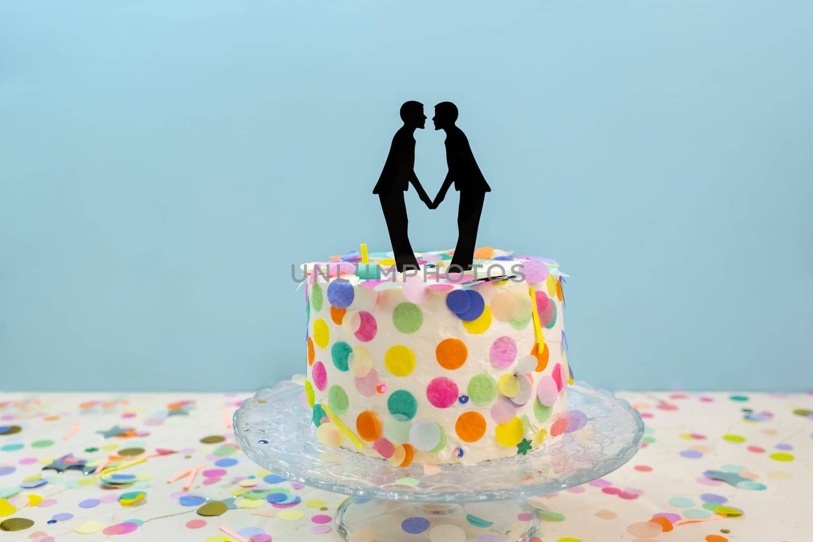 Two grooms cake toppers on decorated wedding cake. Gay wedding concept LGBTQIA by dmitryz