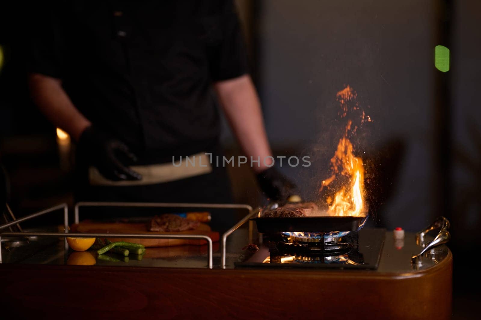 Close-up shot, a professional chef expertly prepares a delicious steak using modern cooking techniques, showcasing culinary excellence and precision in the art of gourmet cuisine.