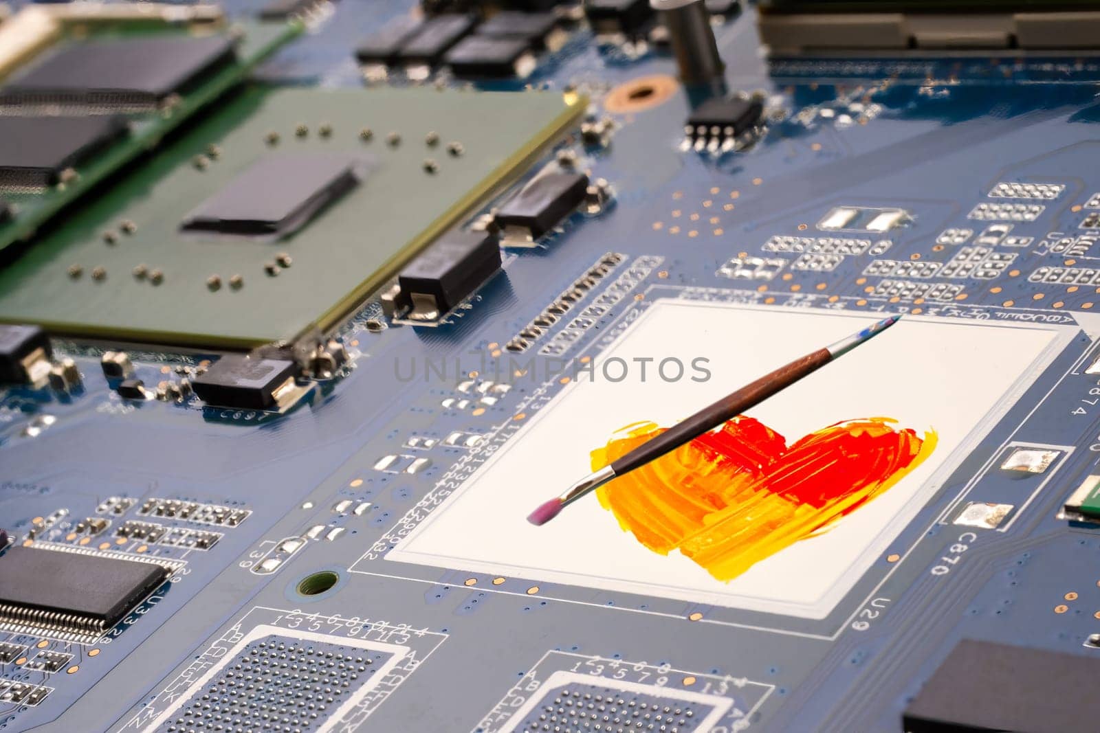AI and artists conflict copyright concept. A PCB motherboard and circuit board featuring a painted heart design and paint brush, symbolizing the conflict at the intersection of technology and human artistic creativity. Selective focus.