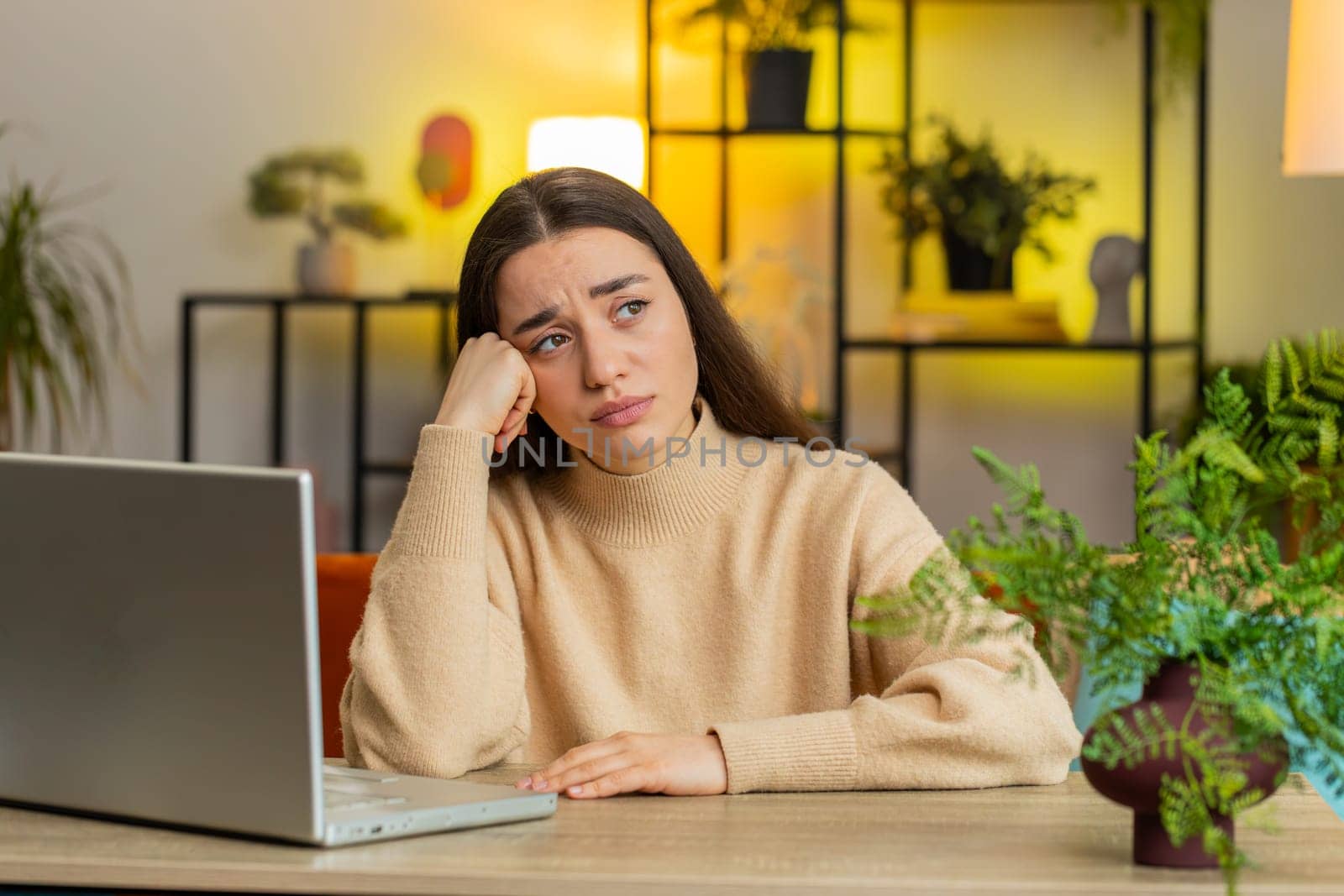 Portrait of sad woman looks pensive thinks over life concerns or unrequited love, suffers from unfair situation. Problem, break up, depressed feeling bad annoyed, burnout. Girl at home office at table