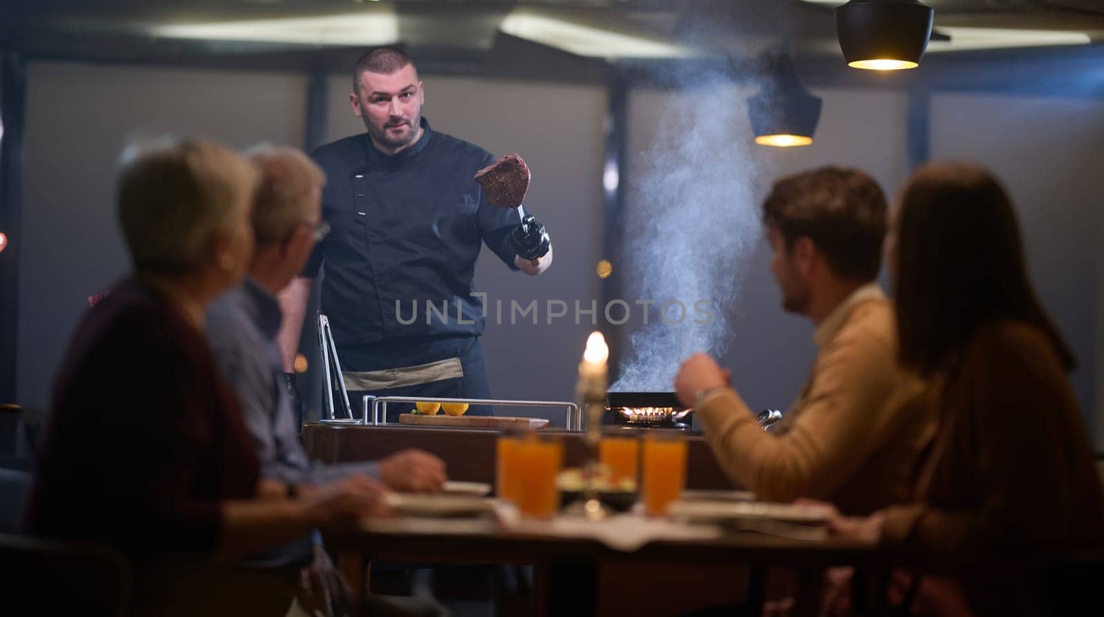 In a restaurant setting, a professional chef presents a sizzling steak cooked over an open flame, while an European Muslim family eagerly awaits their iftar meal during the holy month of Ramadan, blending culinary artistry with cultural tradition in a harmonious dining experience by dotshock