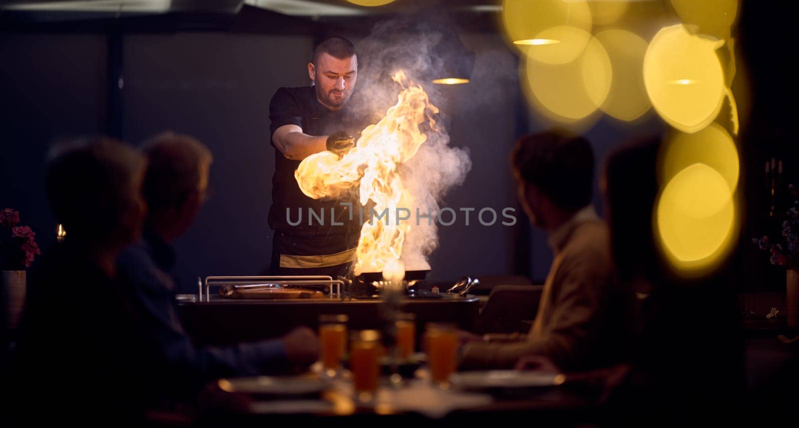 In a restaurant setting, a professional chef presents a sizzling steak cooked over an open flame, while an European Muslim family eagerly awaits their iftar meal during the holy month of Ramadan, blending culinary artistry with cultural tradition in a harmonious dining experience by dotshock