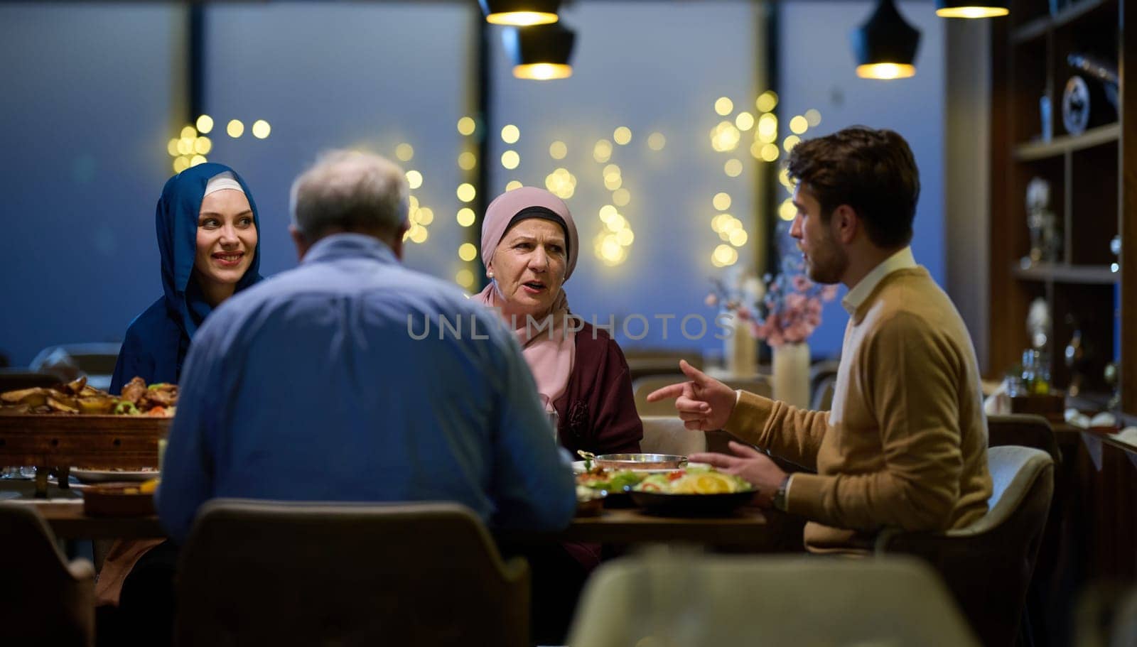 A modern and traditional European Islamic family comes together for iftar in a contemporary restaurant during the Ramadan fasting period, embodying cultural harmony and familial unity amidst a culinary celebration of diversity by dotshock