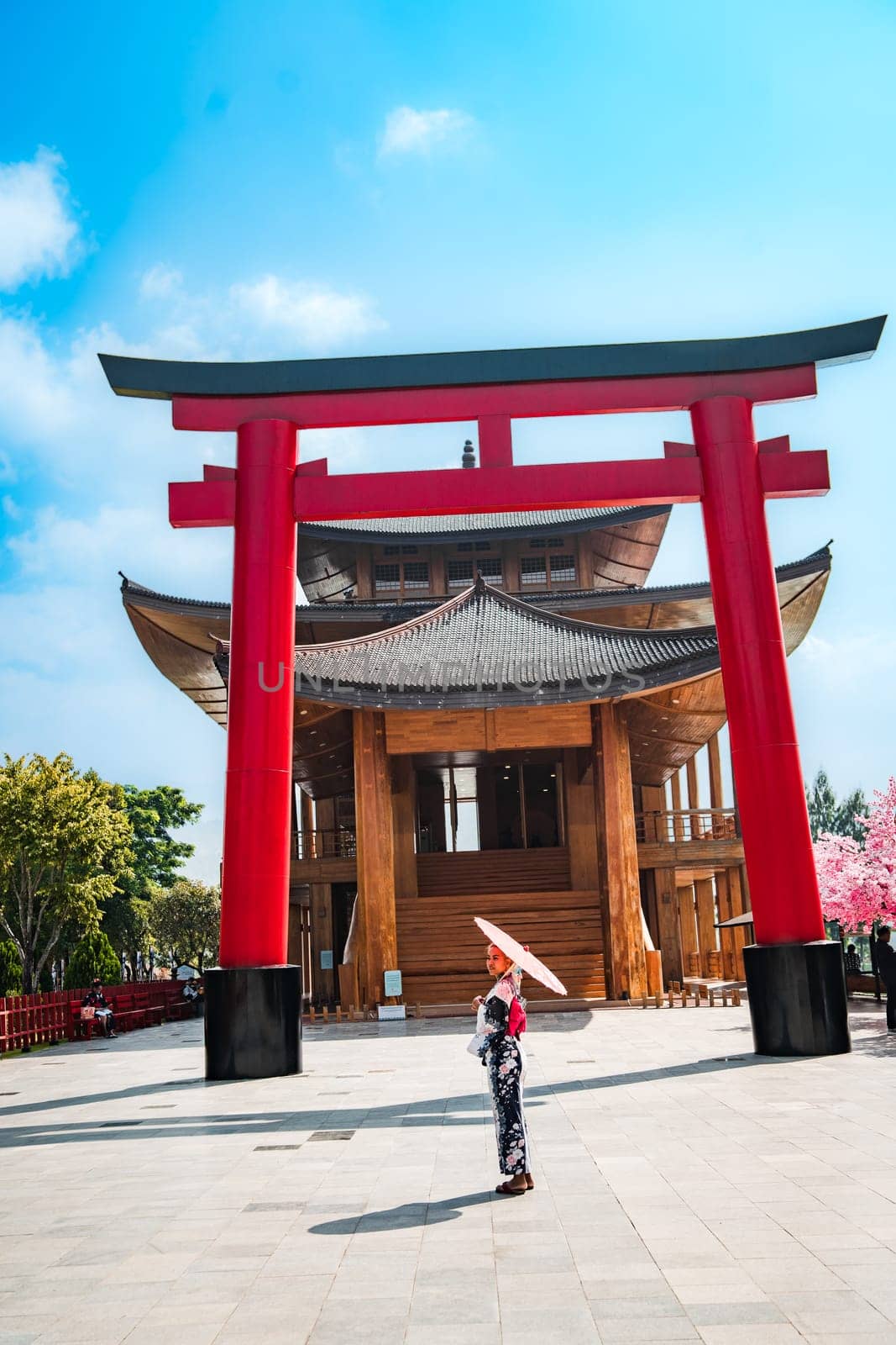 Asian girl in kimono and umbrella in Japanese theme park Hinoki Land in Chai Prakan District, Chiang Mai, Thailand by worldpitou