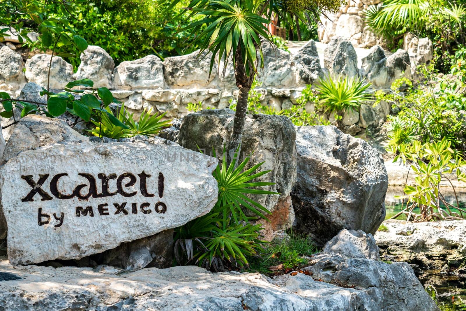 Cancun, Mexico - September 13, 2021: Xcaret theme park sign on big stone in Mexico by Mariakray