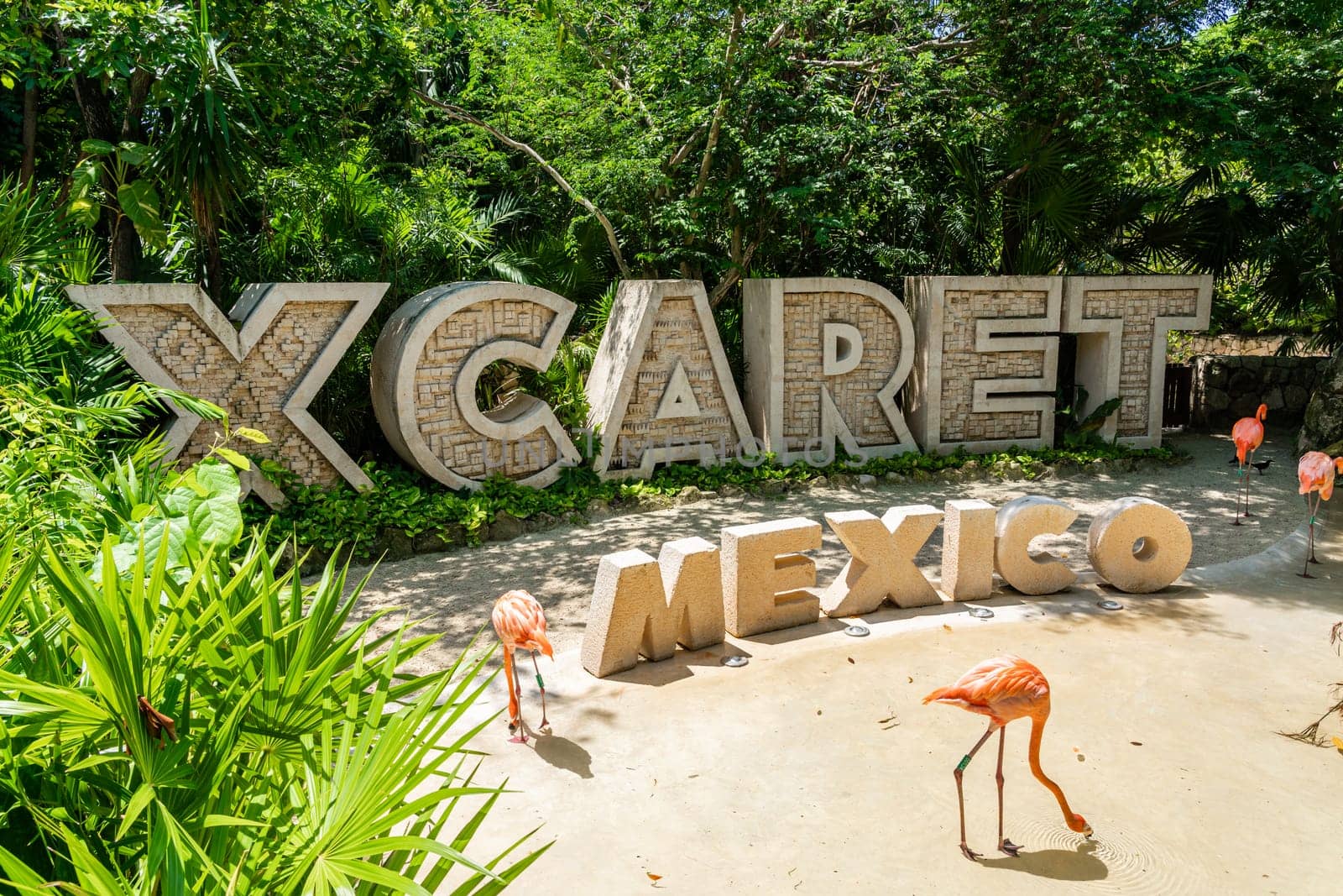 Cancun, Mexico - September 13, 2021: Xcaret theme park entrance sign with pink flamingo in Mexico by Mariakray