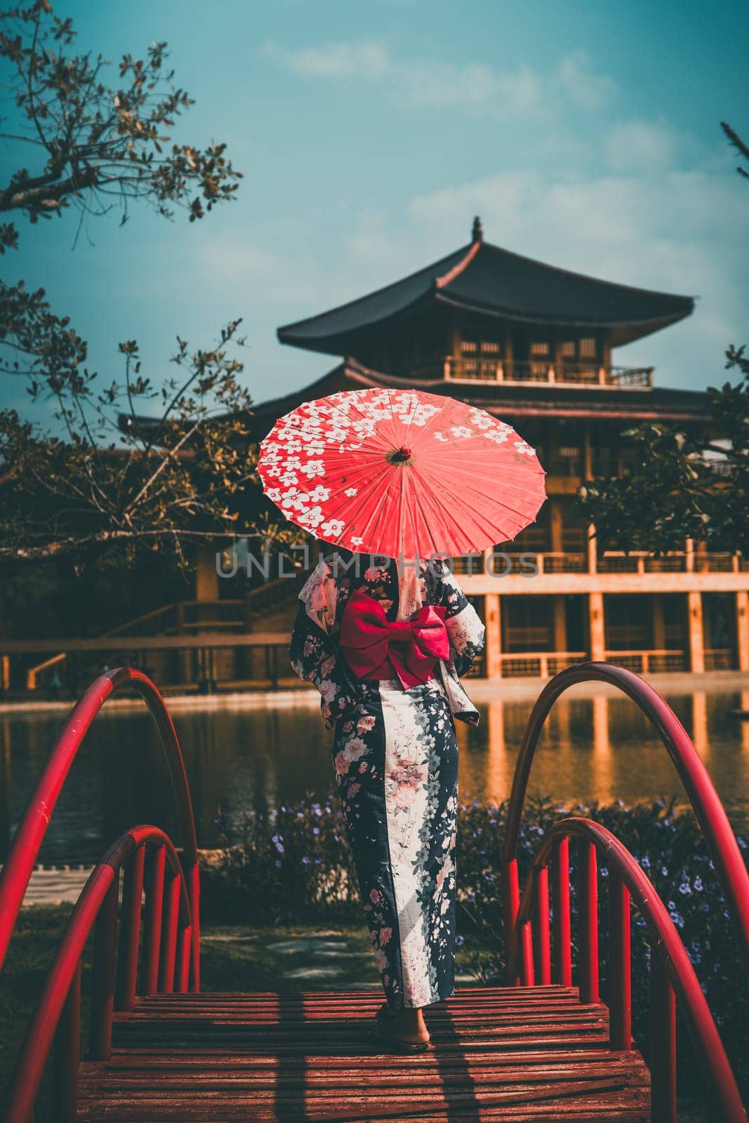 Asian girl in kimono and umbrella in Japanese theme park Hinoki Land in Chai Prakan District, Chiang Mai, Thailand by worldpitou