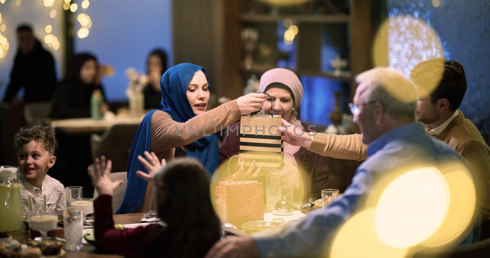 Grandparents arrive at their children's and grandchildren's gathering for iftar in a restaurant during the holy month of Ramadan, bearing gifts and sharing cherished moments of love, unity, and cultural exchange, as they eagerly await their meal together.