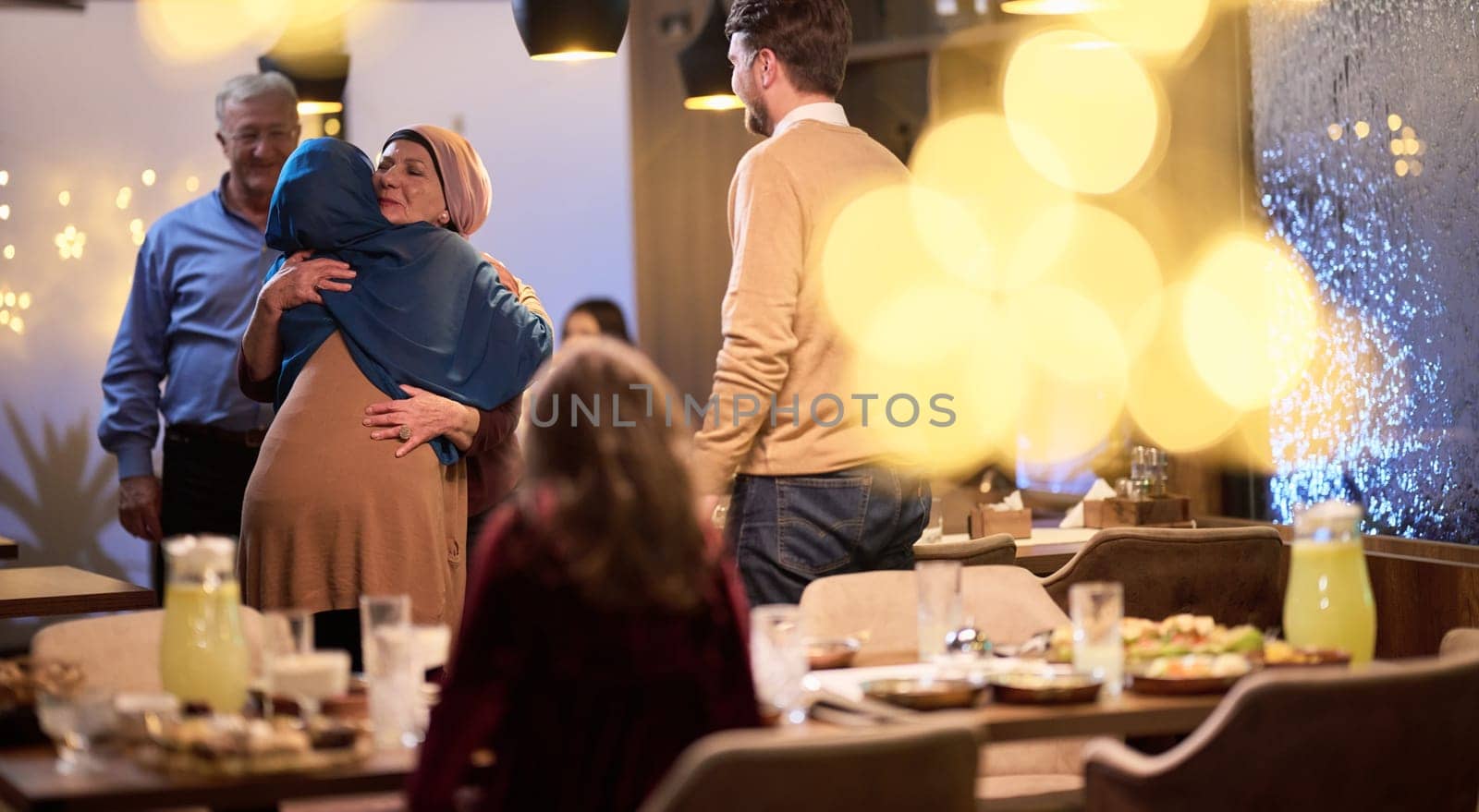 Grandparents arrive at their children's and grandchildren's gathering for iftar in a restaurant during the holy month of Ramadan, bearing gifts and sharing cherished moments of love, unity, and cultural exchange, as they eagerly await their meal together by dotshock