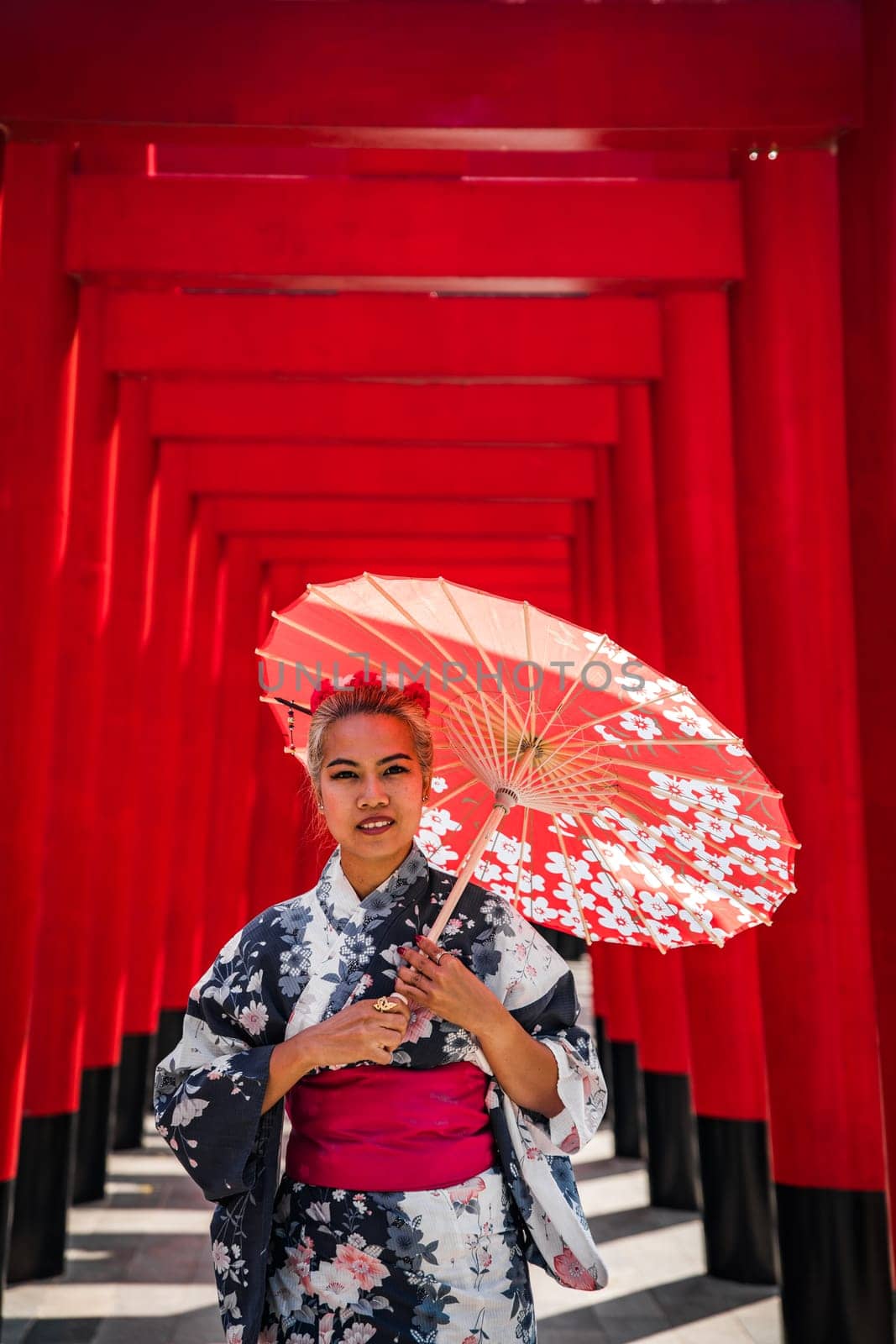 Asian girl in kimono and umbrella in Japanese theme park Hinoki Land in Chai Prakan District, Chiang Mai