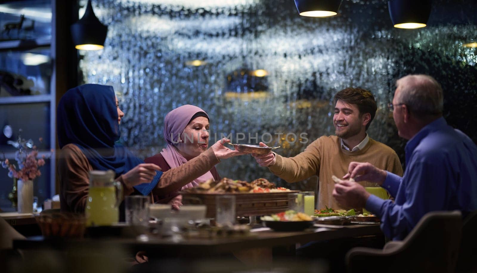 A modern and traditional European Islamic family comes together for iftar in a contemporary restaurant during the Ramadan fasting period, embodying cultural harmony and familial unity amidst a culinary celebration of diversity.