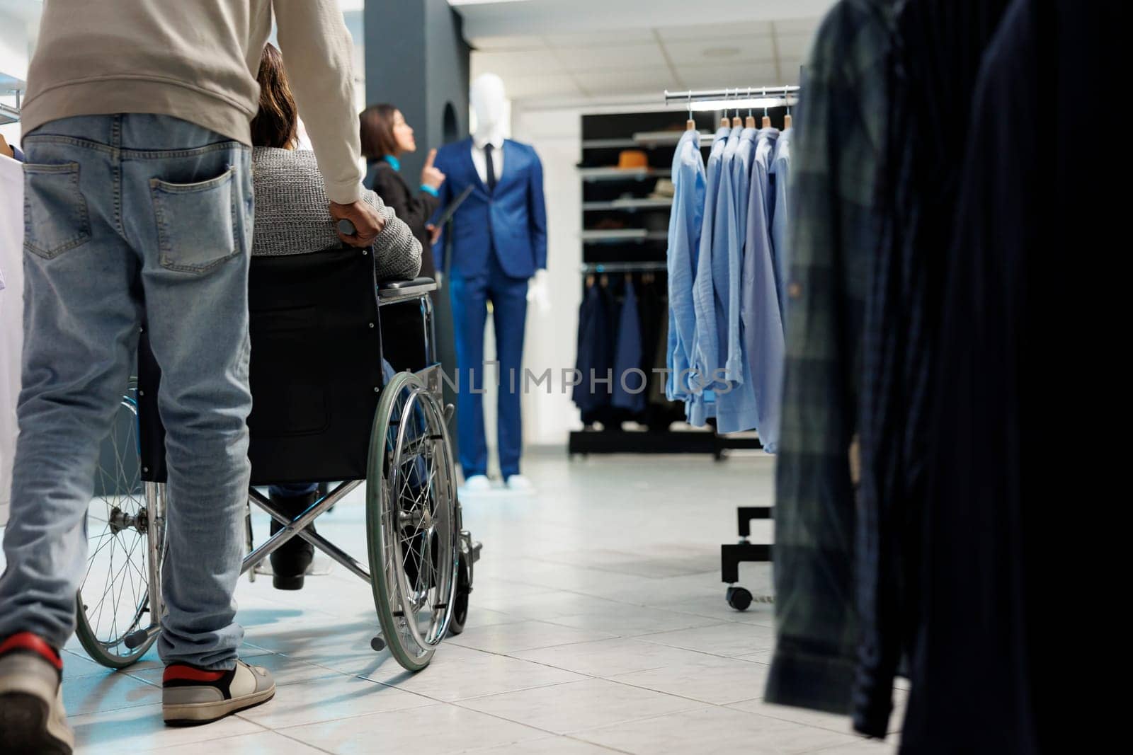 Woman in wheelchair shopping for apparel by DCStudio