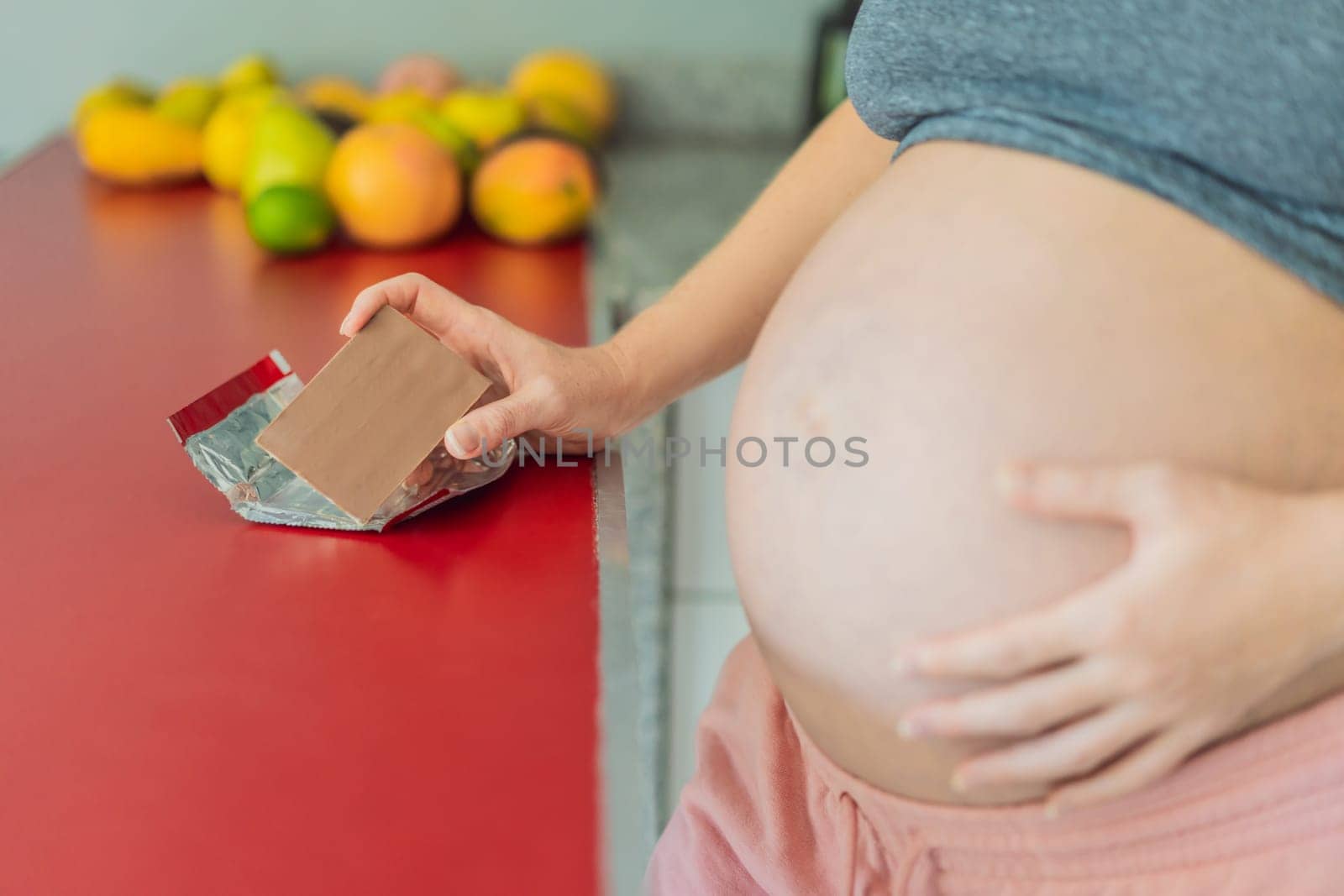 Contemplating the sweet dilemma, a pregnant woman ponders the decision to indulge in chocolate during pregnancy, weighing the delightful treat's potential impact on her maternal journey by galitskaya