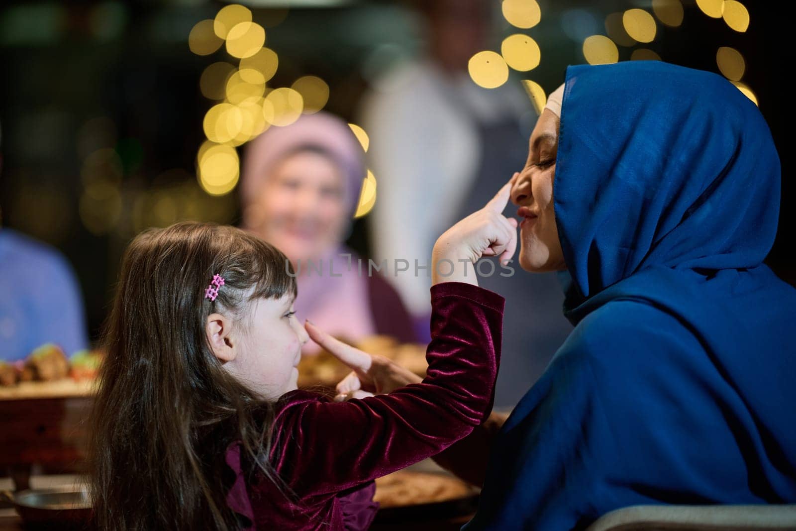 In a heartwarming scene, a happy European Islamic family and a young girl delightfully engage with her mother while eagerly anticipating their iftar meal, radiating joy, love, and familial bonding during the holy month of Ramadan