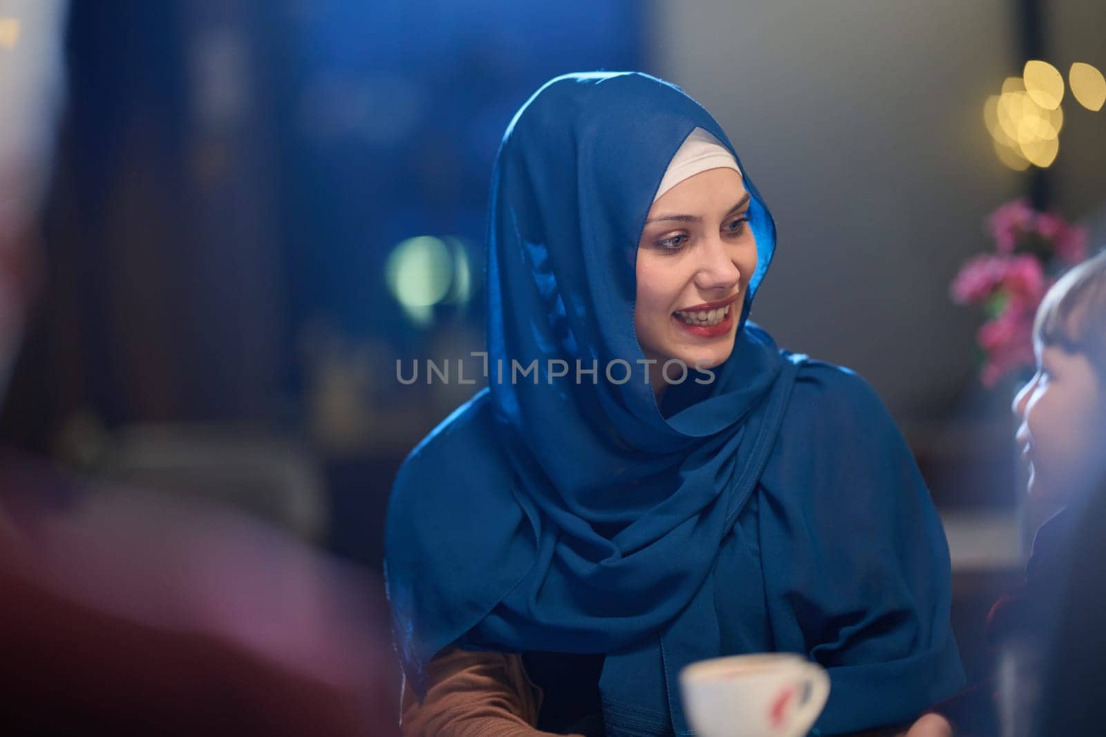 In a modern restaurant, a beautiful European Muslim woman gracefully enjoys the ambiance and culinary delights during the holy month of Ramadan, embodying elegance and spiritual serenity amidst cultural celebration.