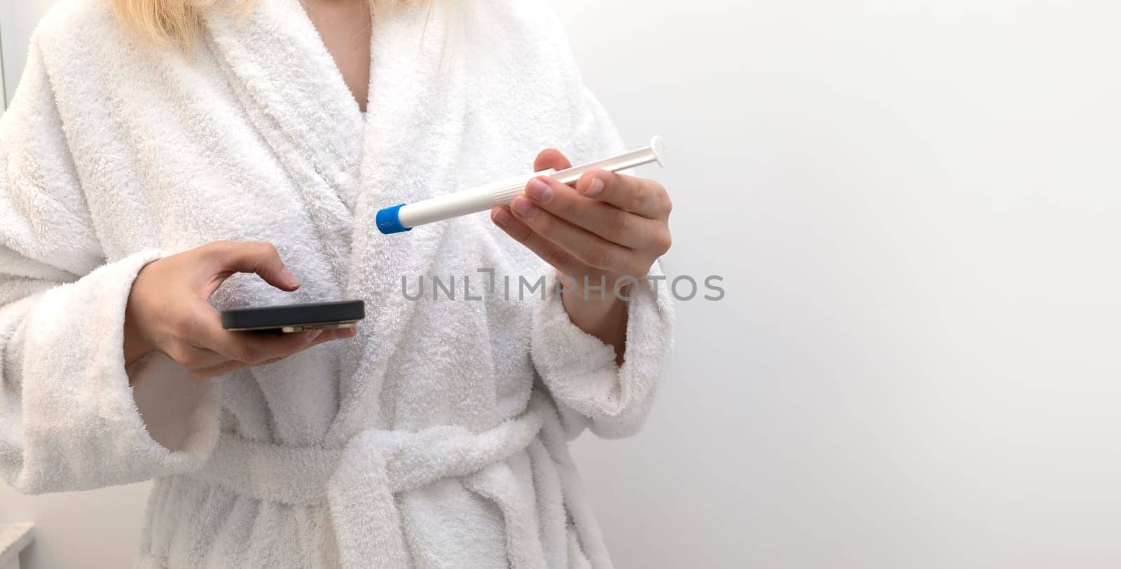 Woman Holds Device and Pre-filled Applicator With Vaginal Antifungal Treatment Cream Or Gel. Female Is Ready To Insert Tioconazole Remedy, Ointment Against Infections. Space for Text Horizontal Plane.