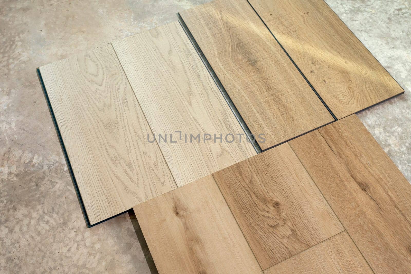 Top View Luxury Vinyl Wood Samples Lying On Concrete Floor In House. Choosing, Selecting Waterproof Flooring. Home Reconstruction. Vinyl Tiles Collection, Patterns. Interior Design Idea. Horizontal. by netatsi