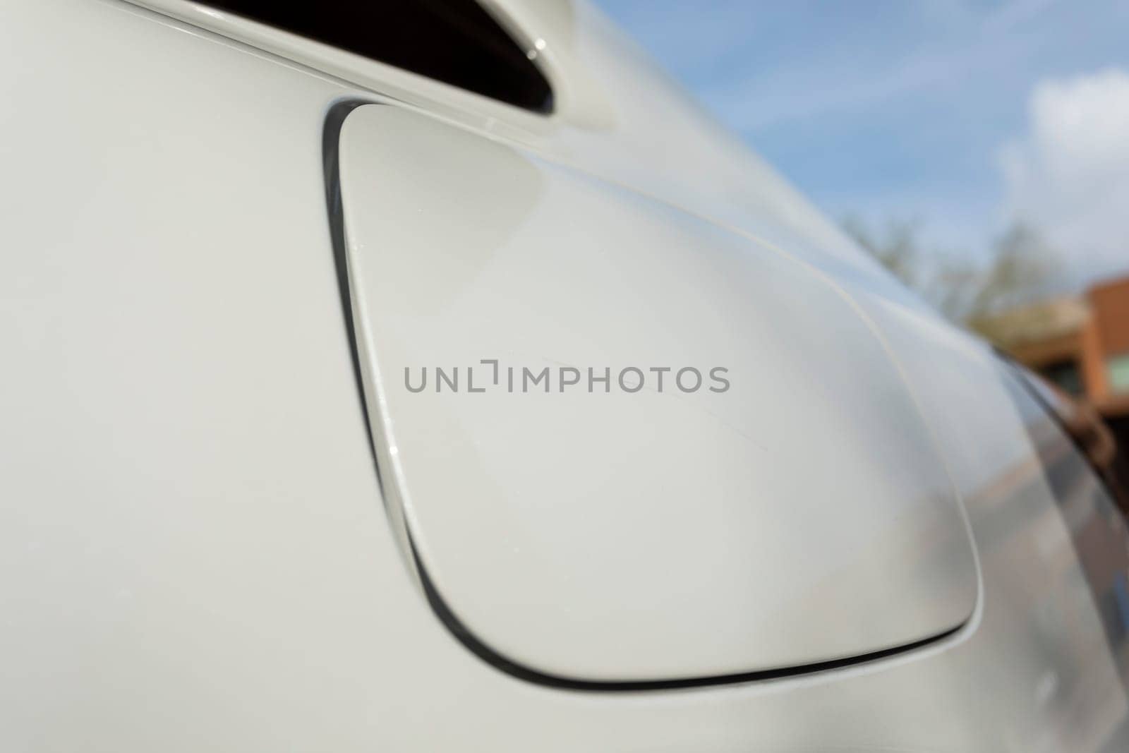 Closeup Scratch On Cap Of Filler Neck, Gas Tank Of White Car. Paint Or Polishing The Clear Coat With A Rubbing Compound. Car Dent Repair. Blue Sky On Background by netatsi