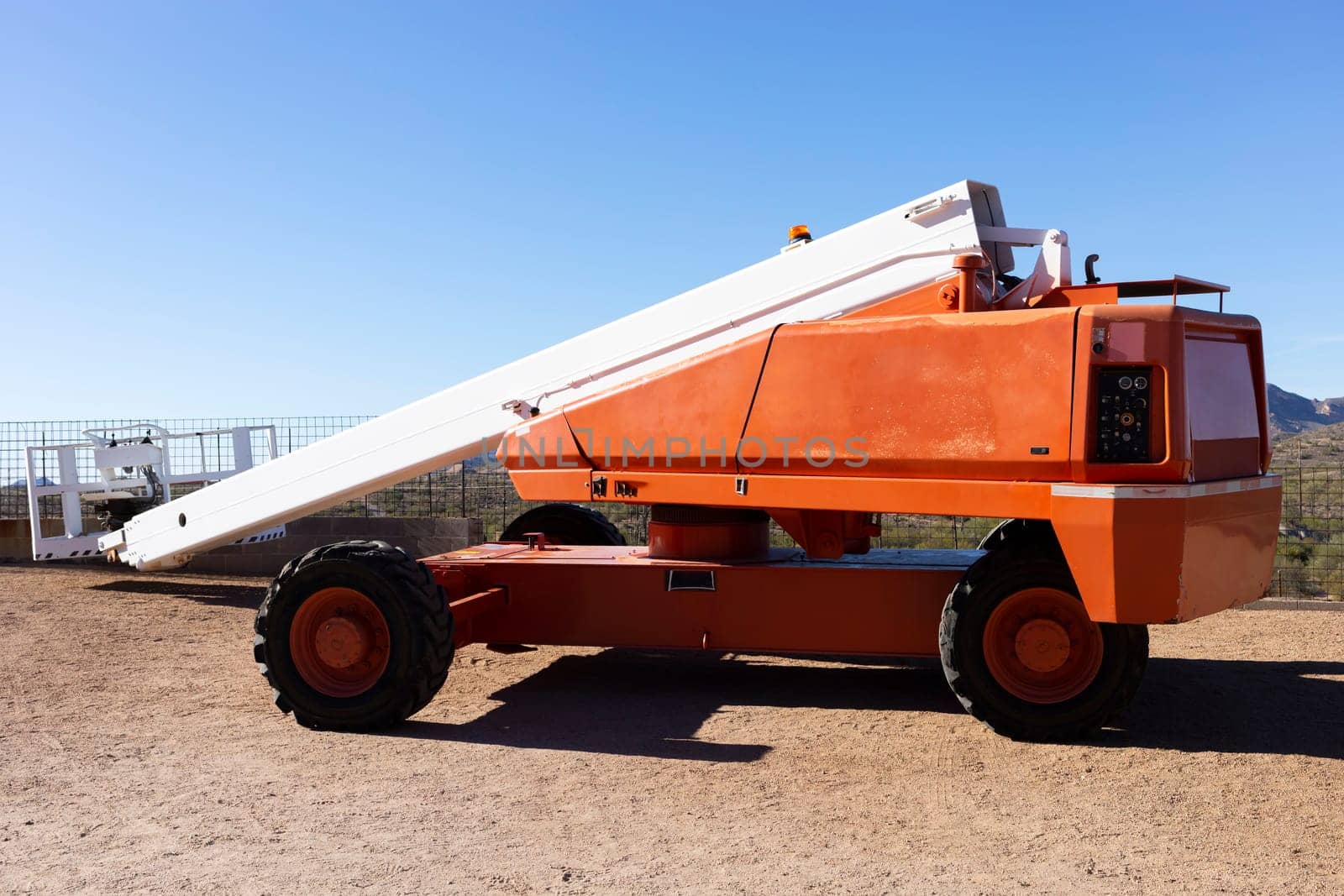 Telescopic Boom Lift For Construction, Painting, Electrical Work And Industrial Maintenance. Truck, Blue Sky On Background. Manlifting Cranes. Self Propelled Wheeled Hydraulic Articulated Boom Lift. by netatsi