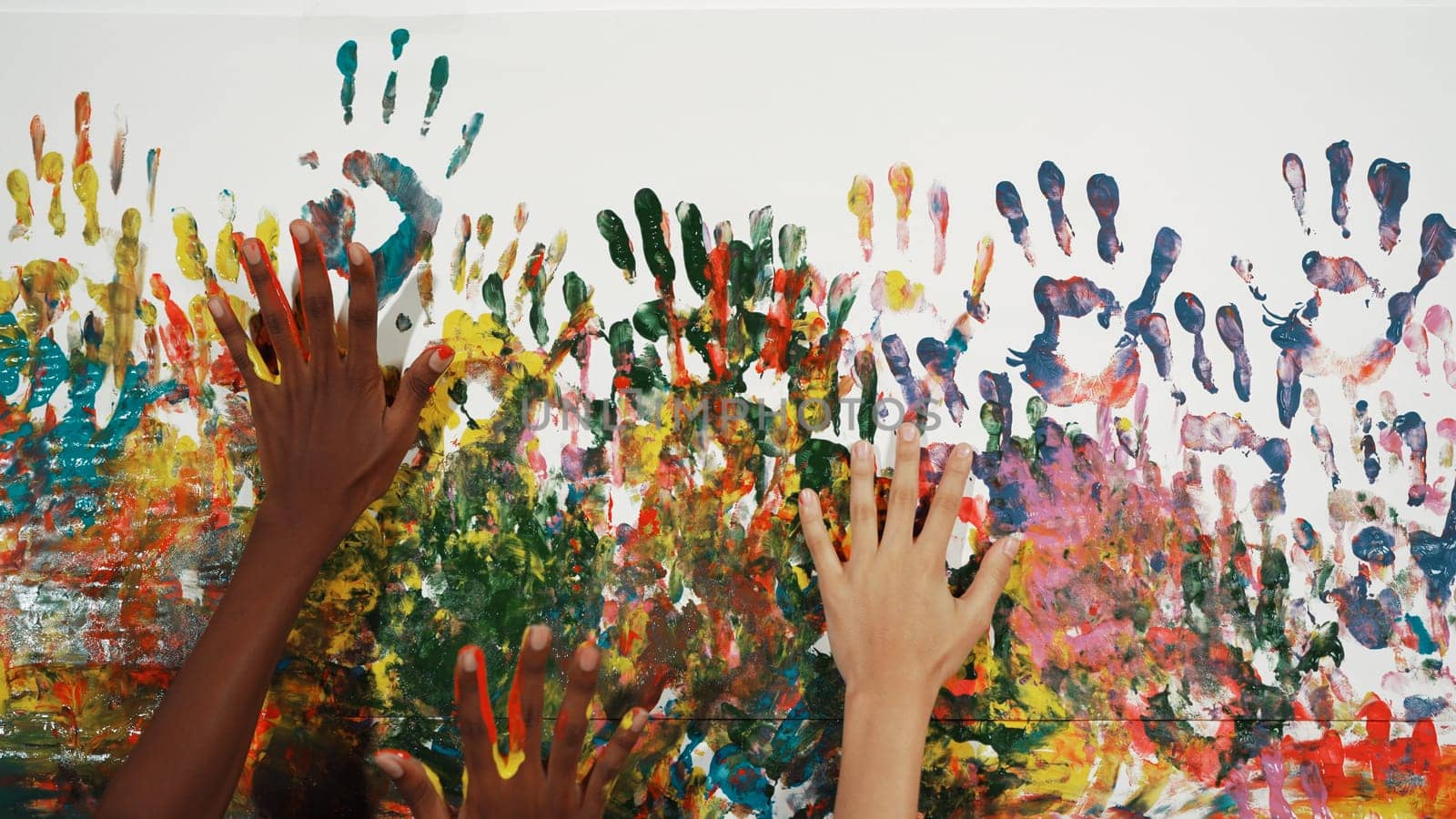 Diverse student hand placed on colorful stained wall. Background. Edification. by biancoblue