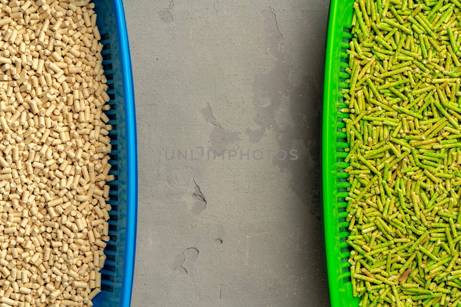 Pet litter tray with wooden filler on gray background close up