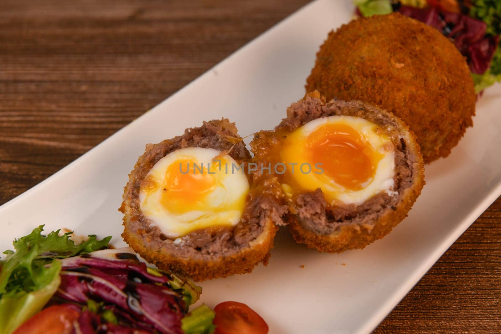 RECIPE FOR BREADED BEEF MEATBALLS STUFFED WITH A SOFT BOILED EGG by FreeProd